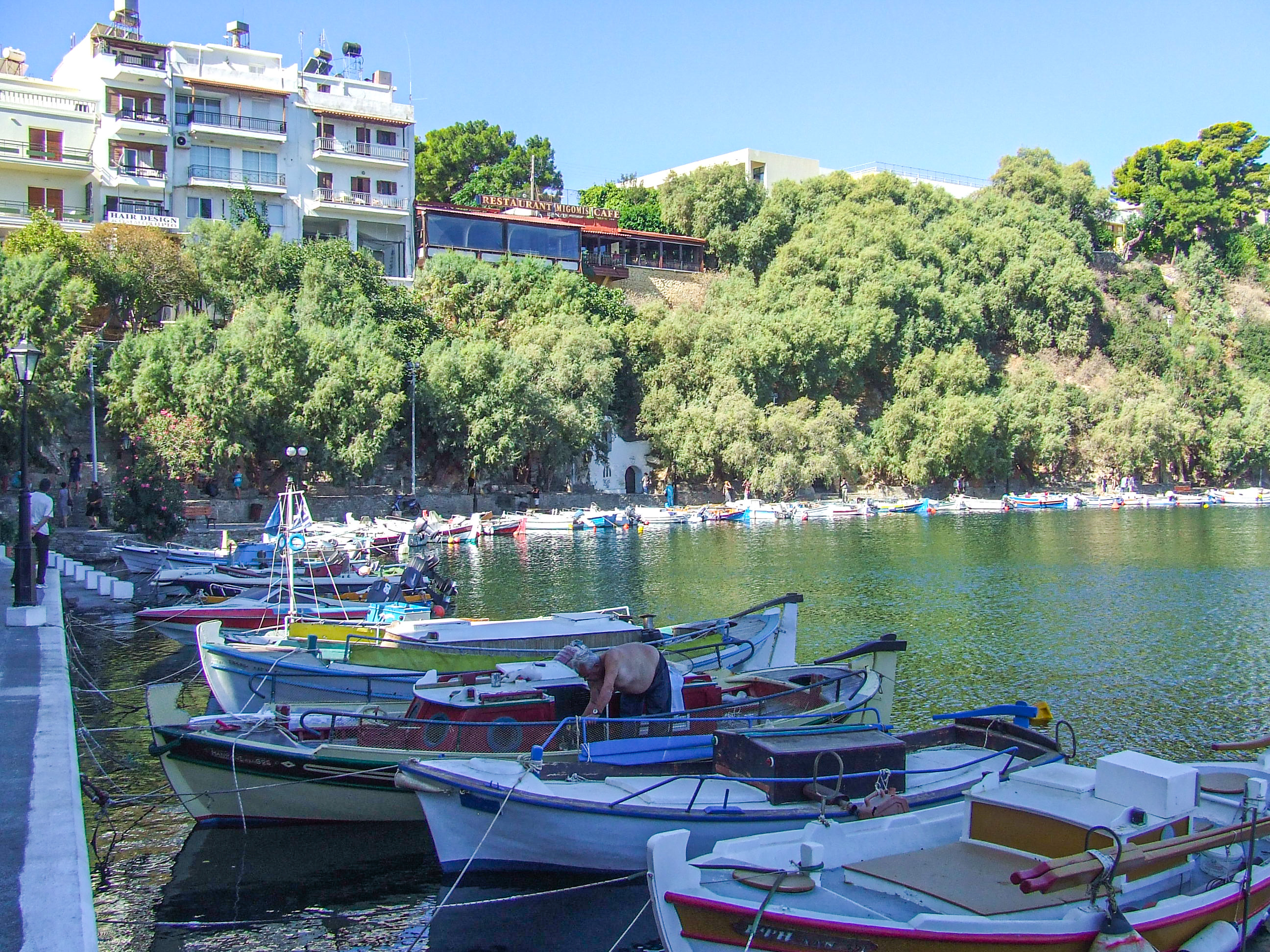 several small boats docked along a waterfront