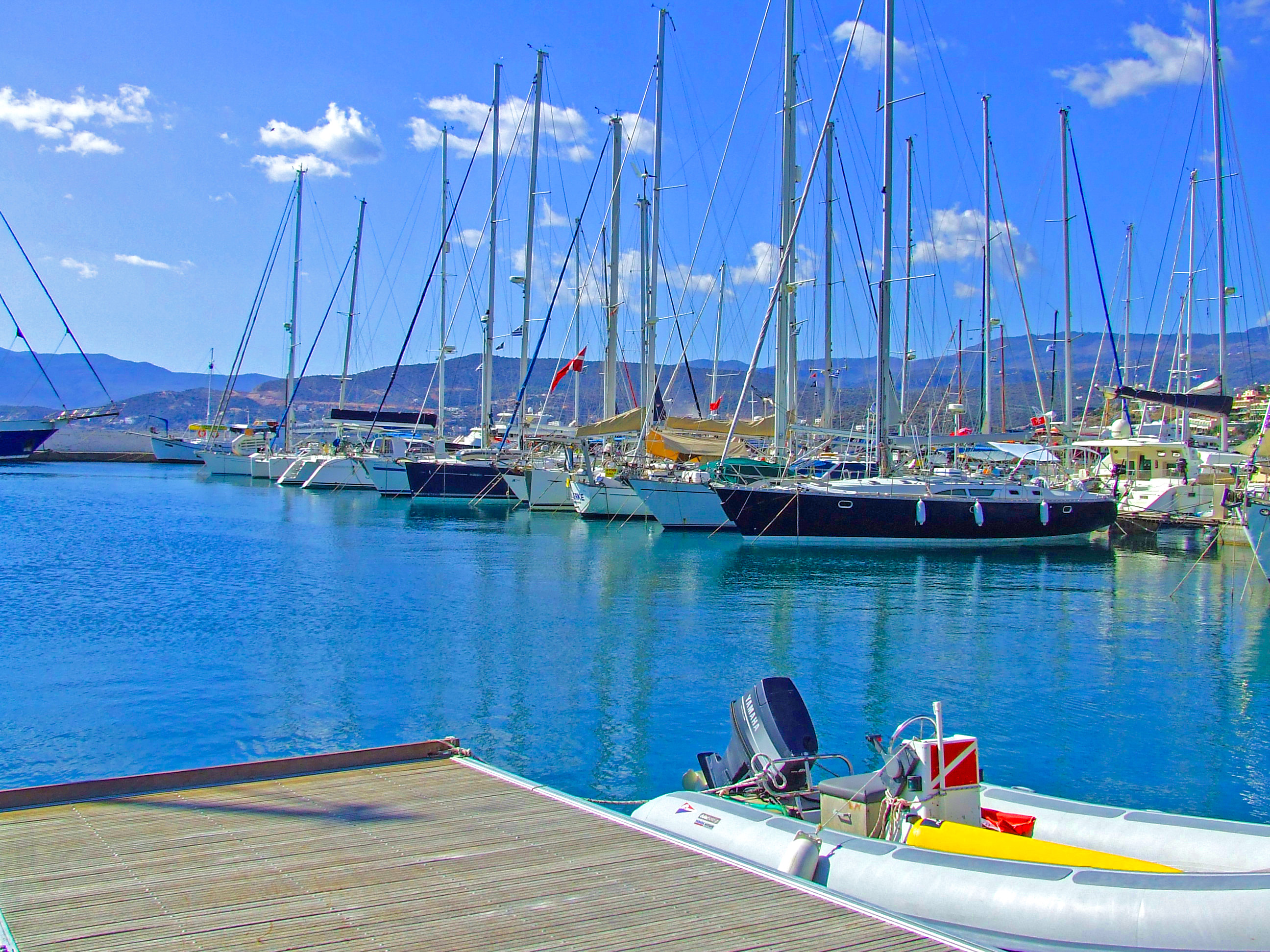 sailboats and yachts docked at the pier