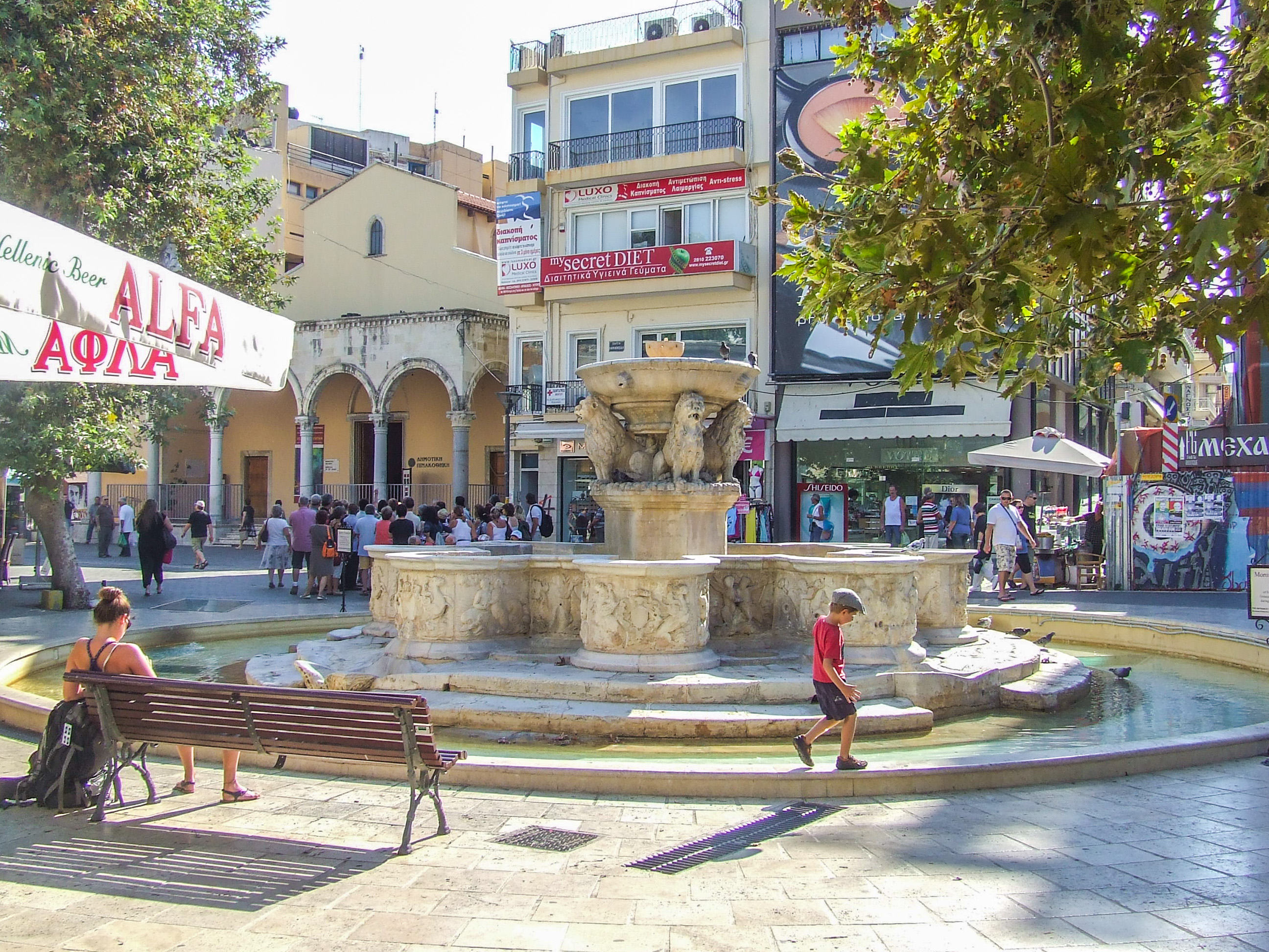 urban square with a prominent stone fountain at its center