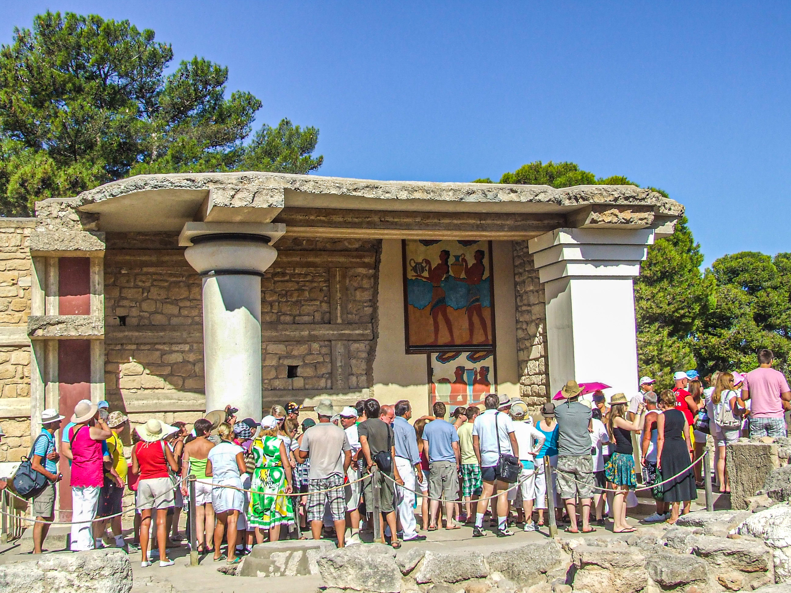 tourists gathered around an ancient structure