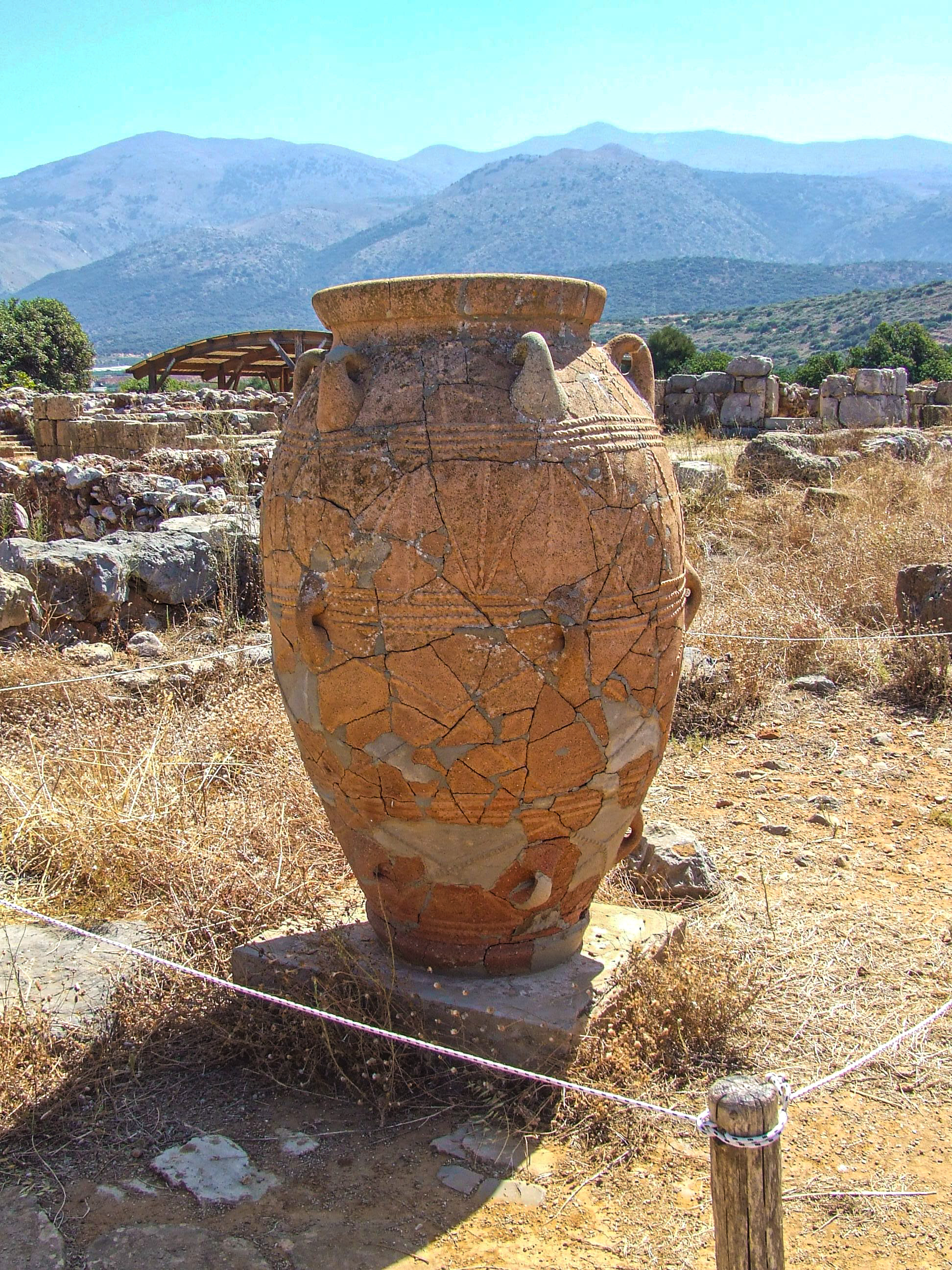 cracked clay jar situated in a dry, rocky landscape
