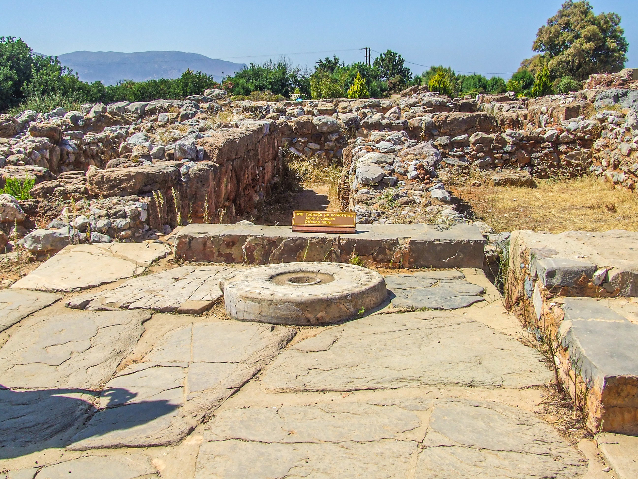 backdrop of rolling hills and distant mountains under a clear blue sky