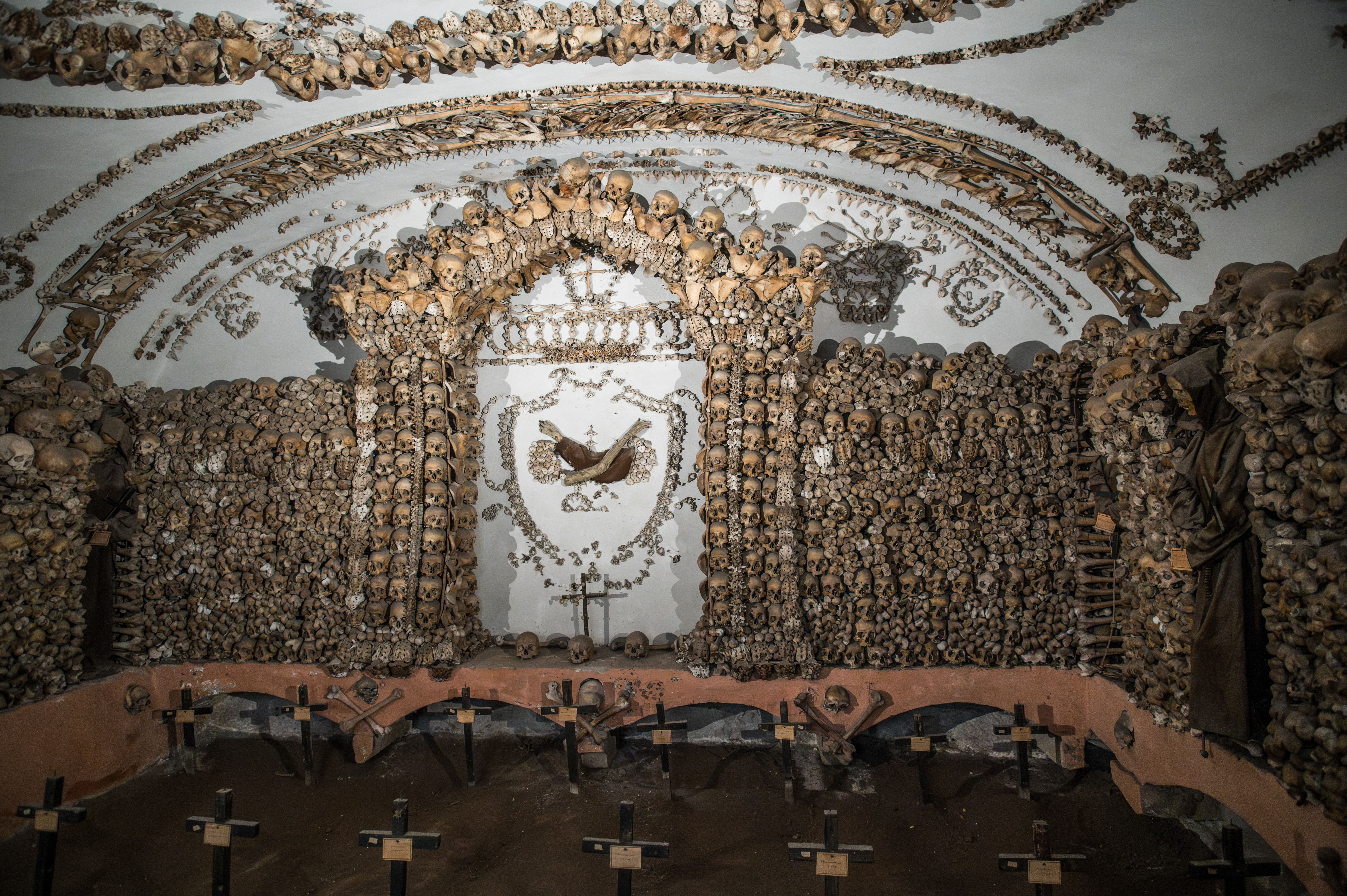 altar features a cross and a sculpture of the Virgin Mary and baby Jesus
