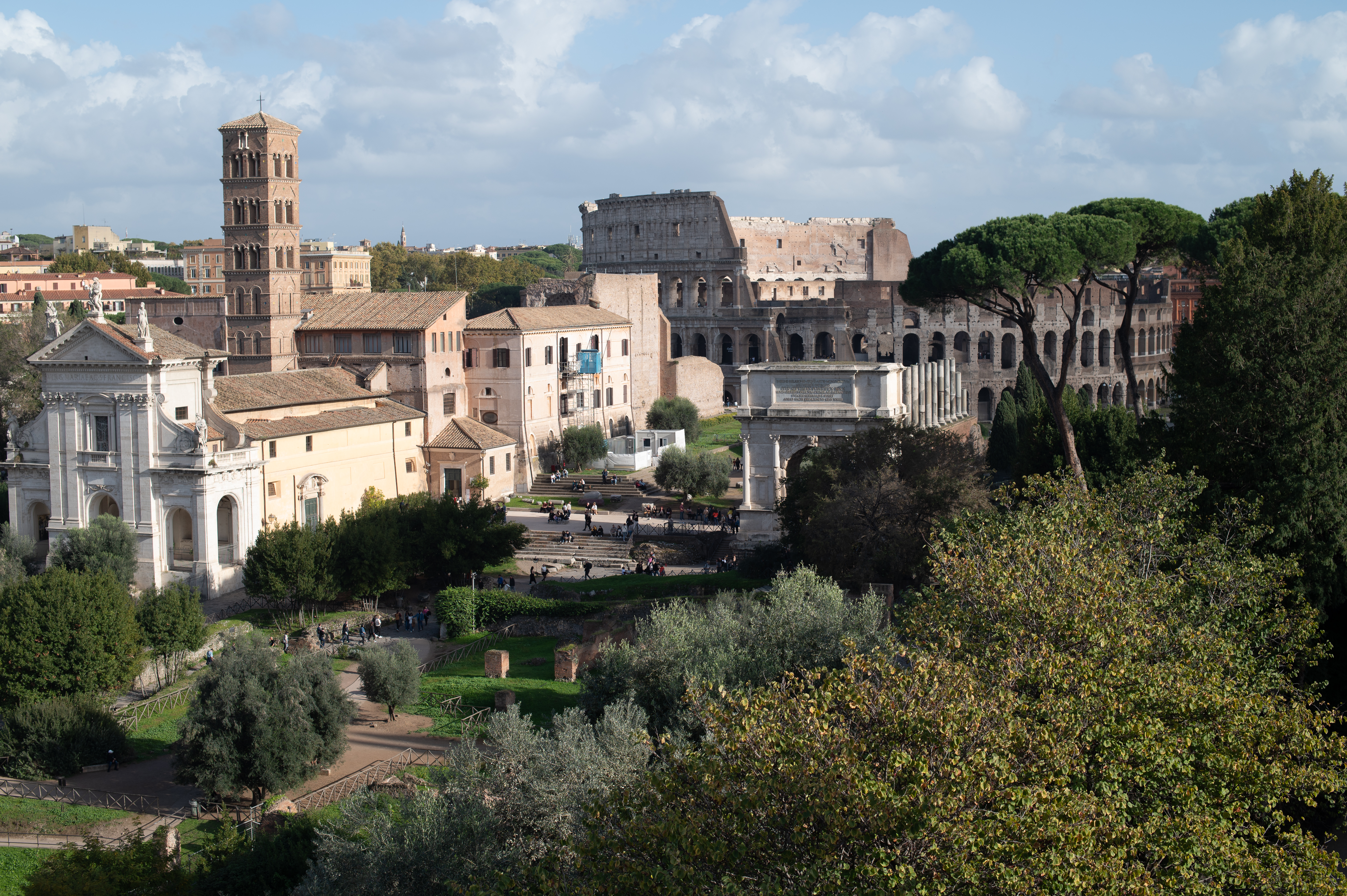 The image depicts a panoramic view of the Colosseum