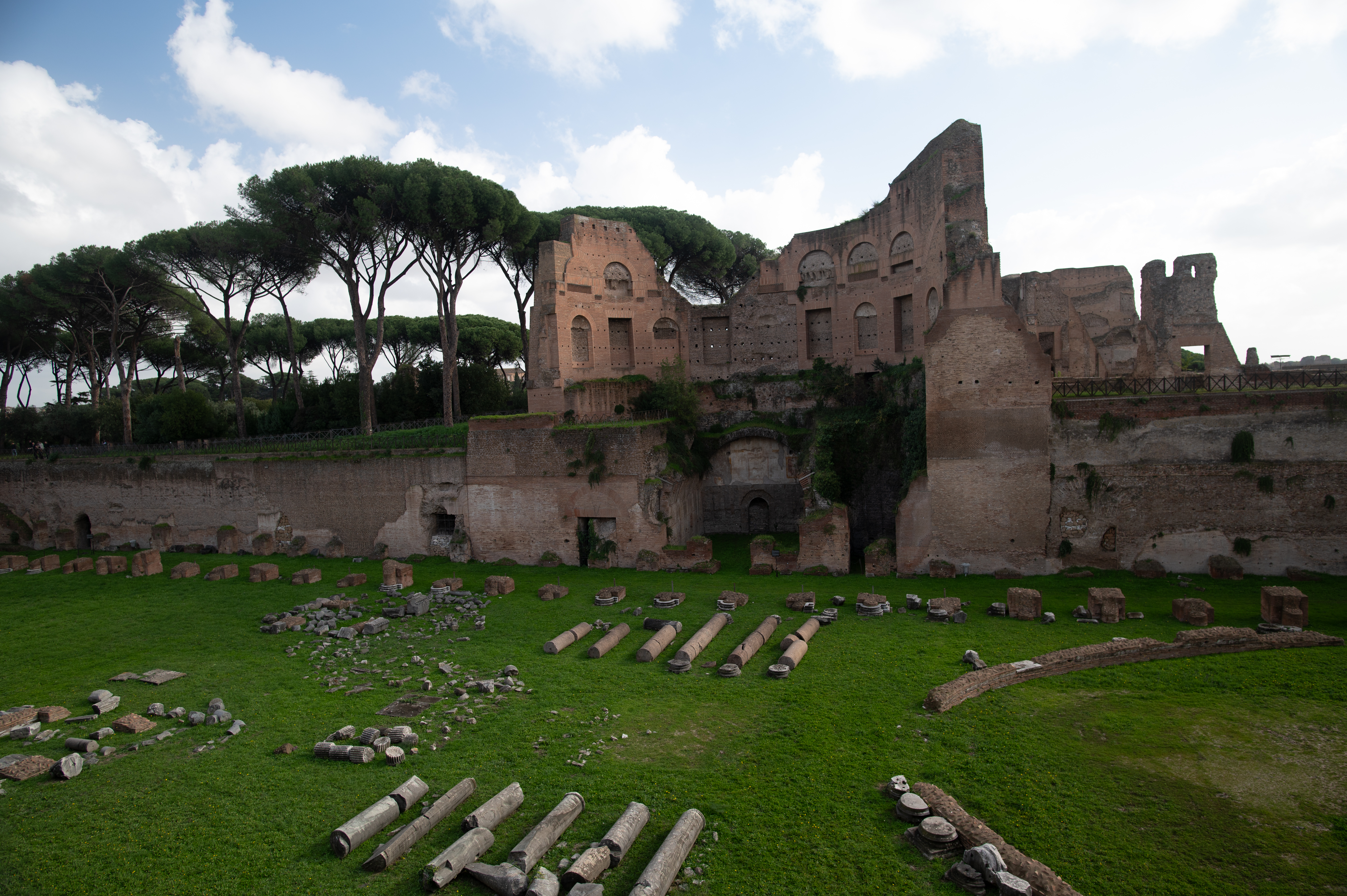ruins are surrounded by scattered stone remnants and cylindrical columns