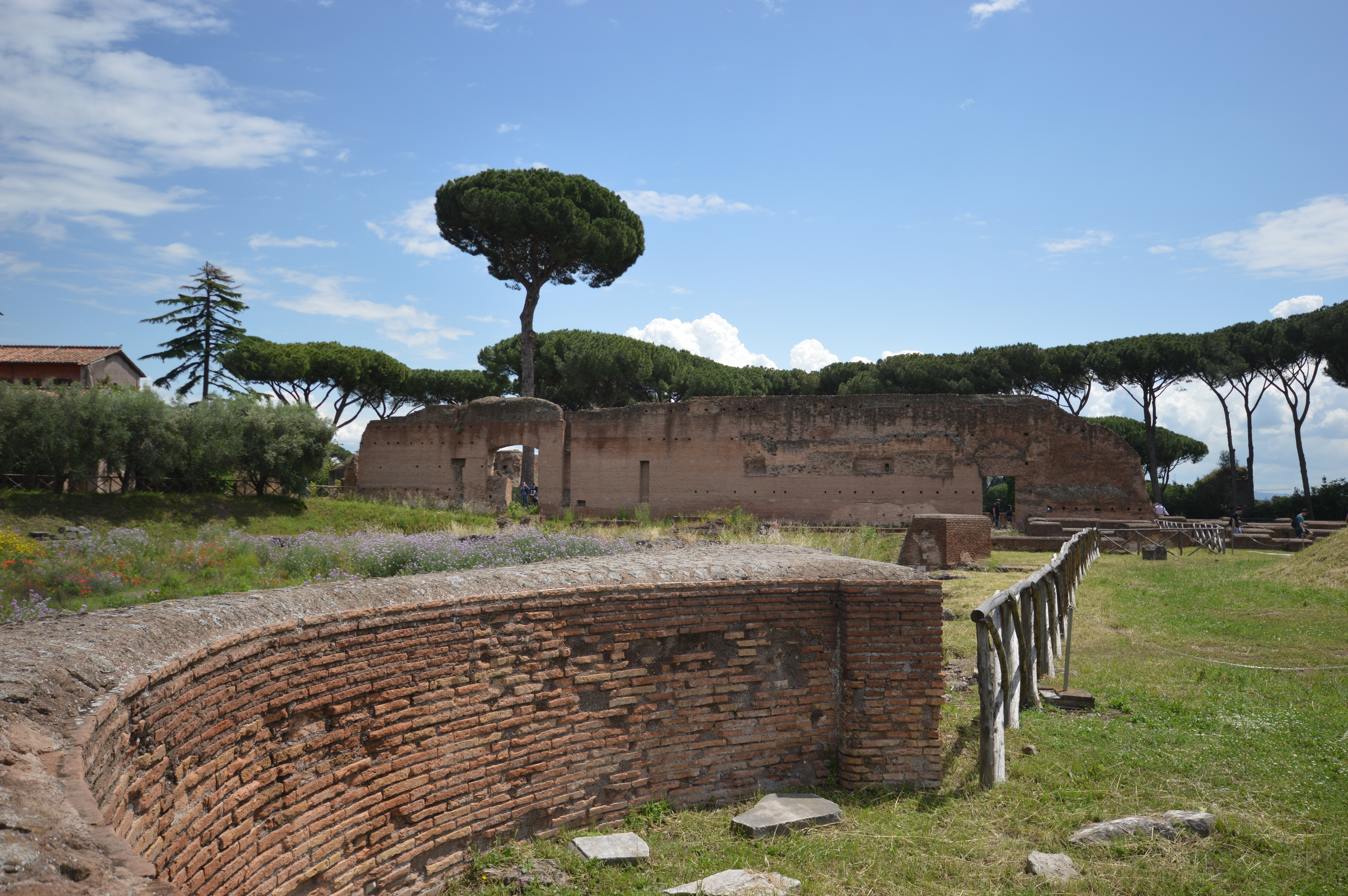 ancient ruins with brick structures and a partially collapsed wall