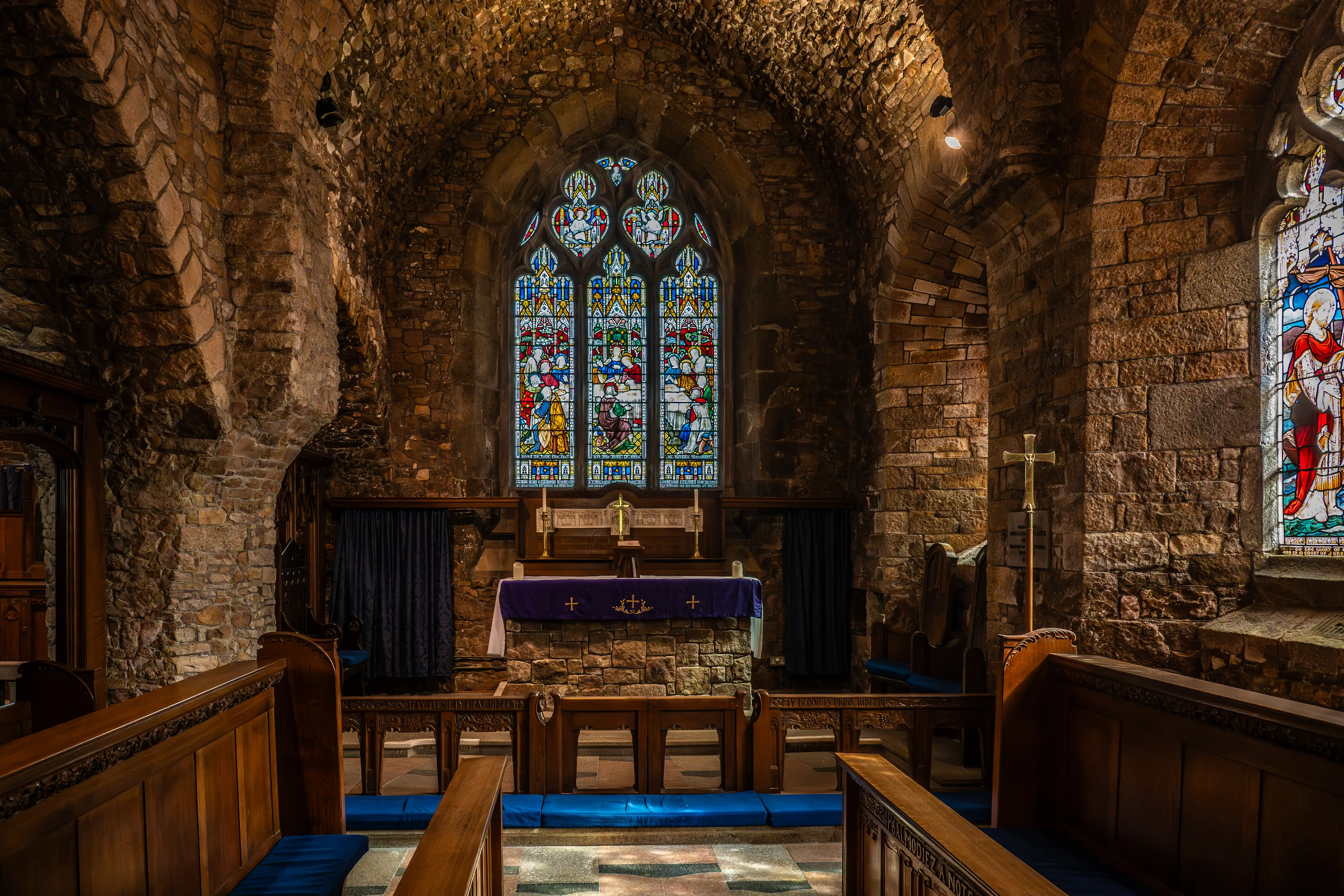  Interior of a Historic Stone Church with Stained Glass Window