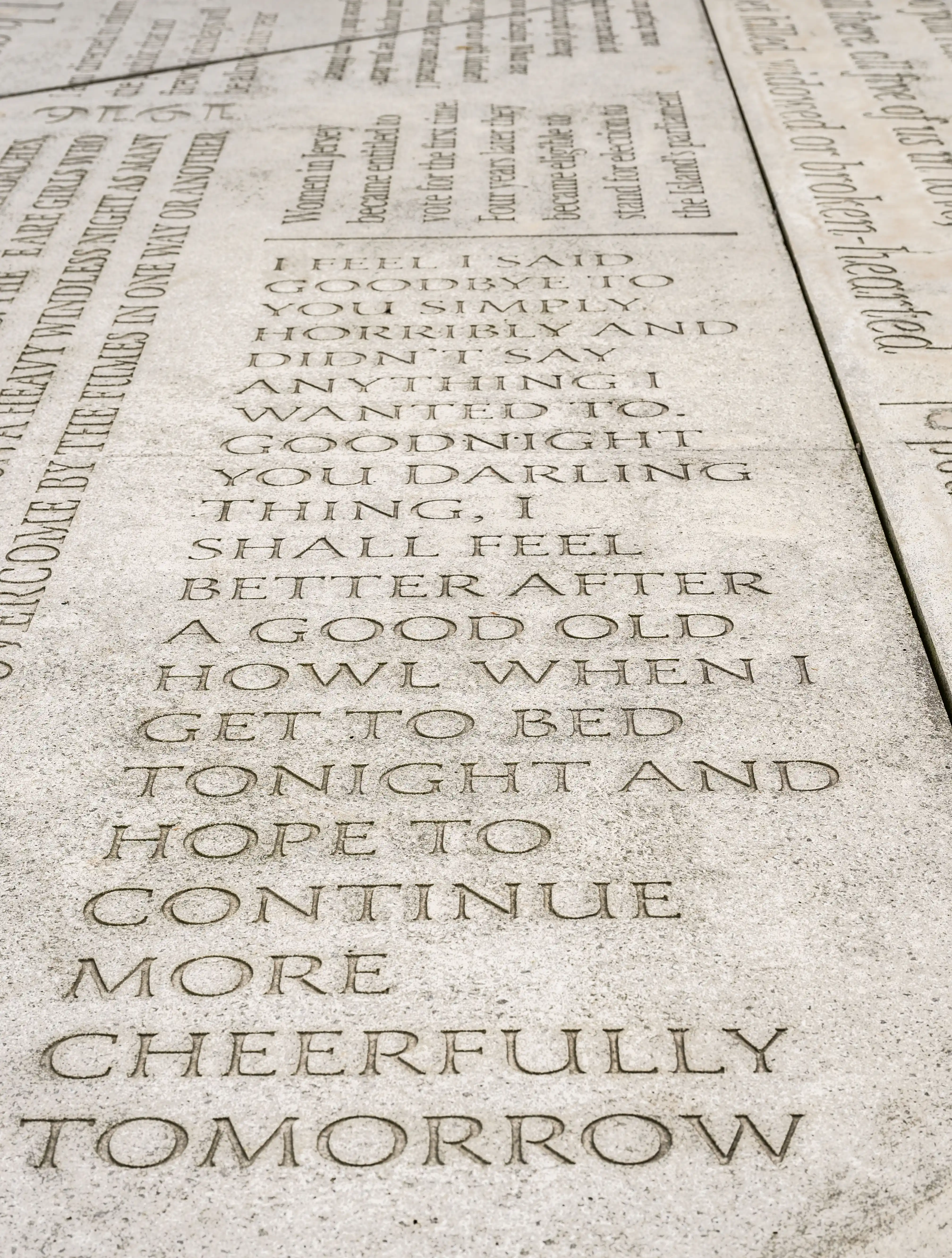 Engraved stone text, featuring a poem about goodbyes and continuing with hope.