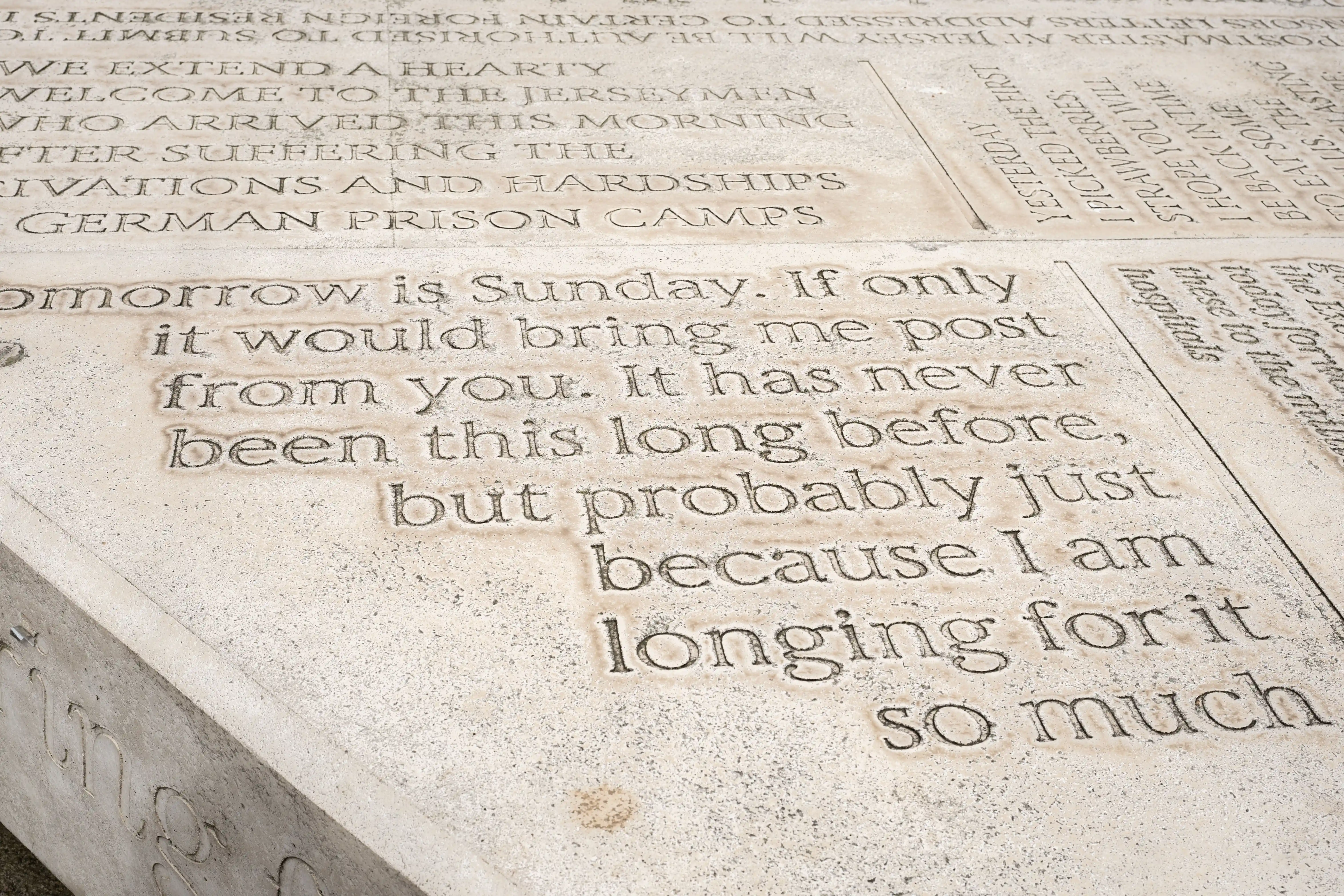 Close-up of a stone memorial with engraved text, including phrases like 