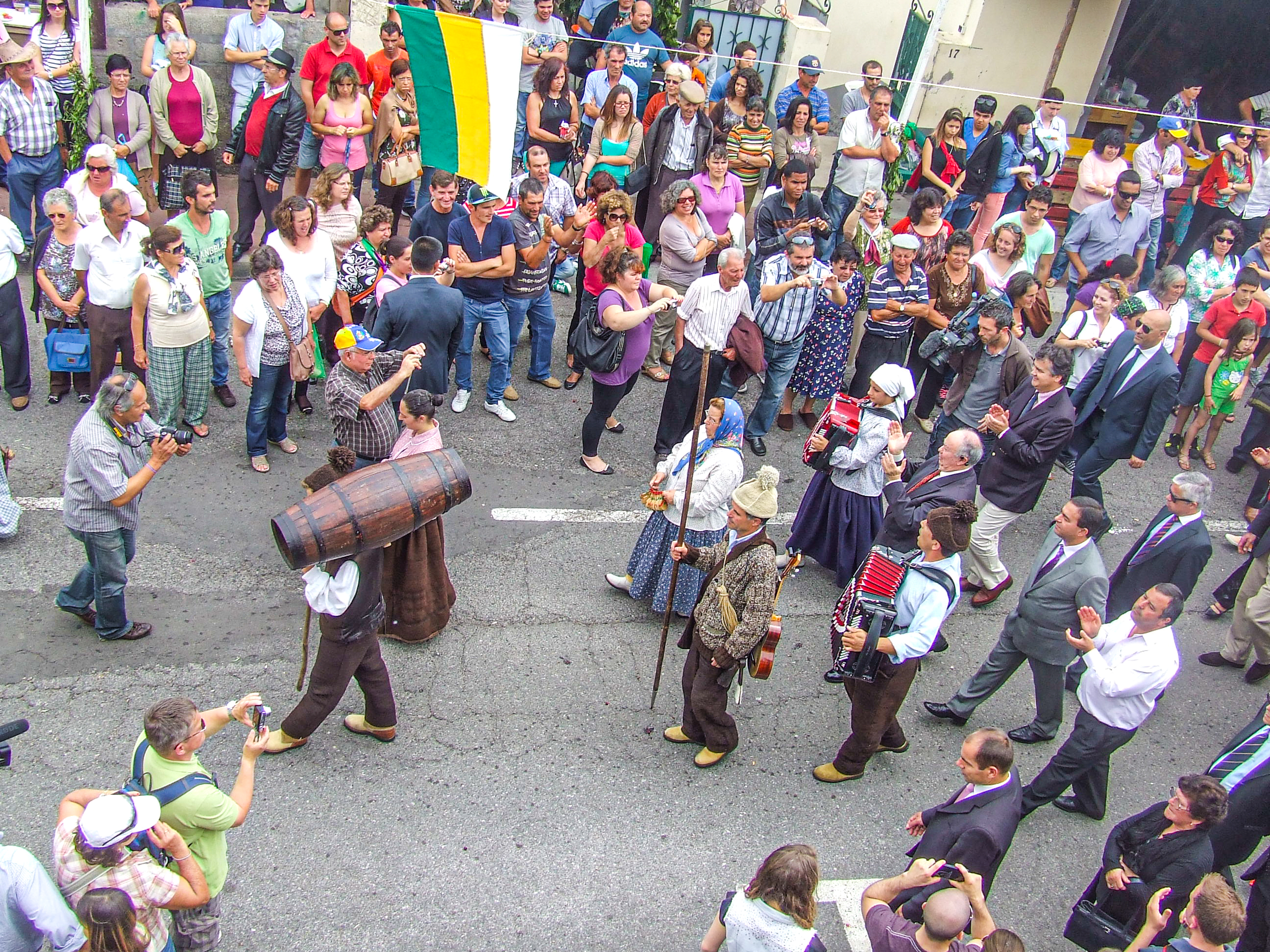 people gathered to watch a traditional parade or procession