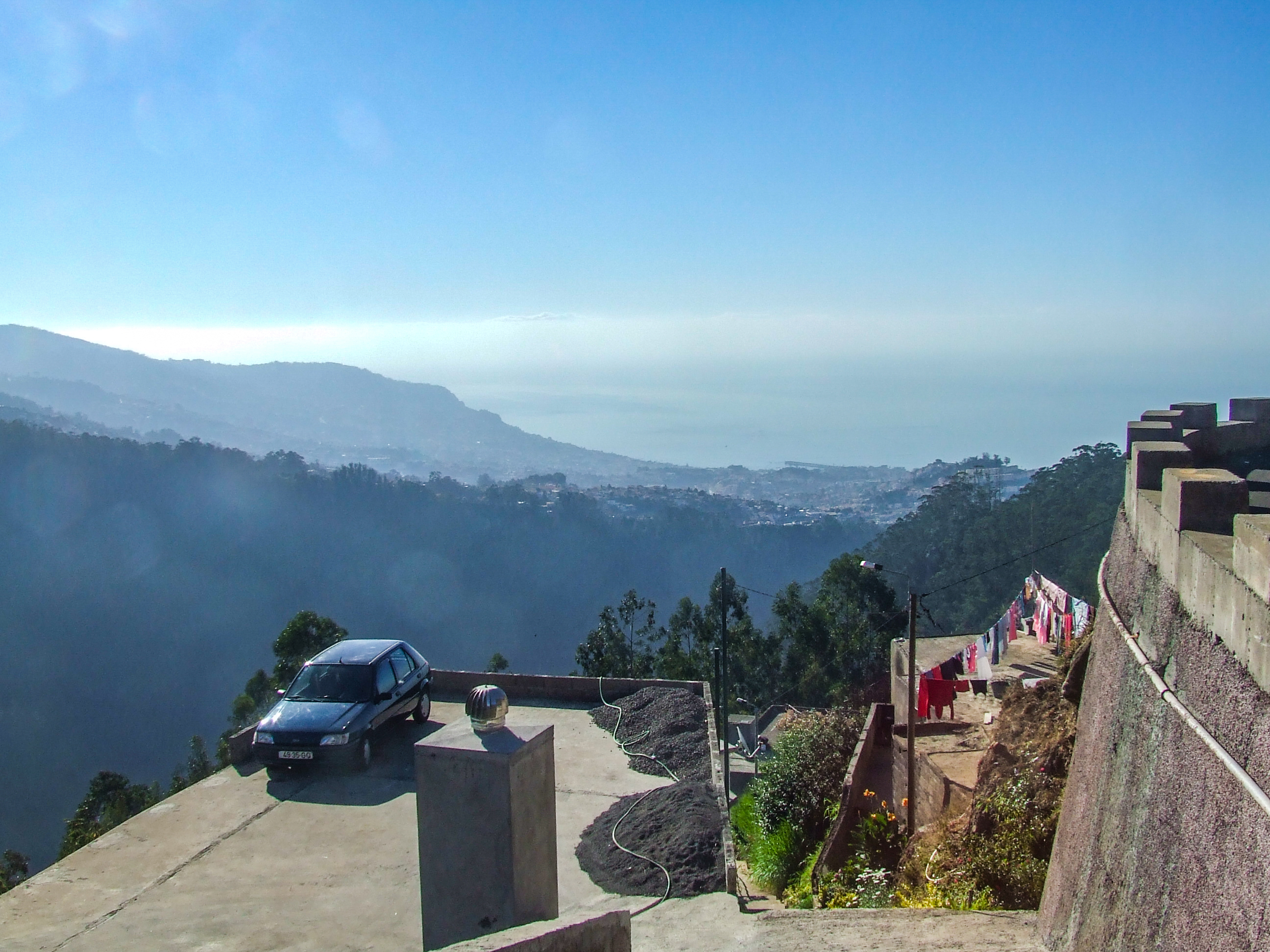 overlooking a vast expanse of greenery and distant hills