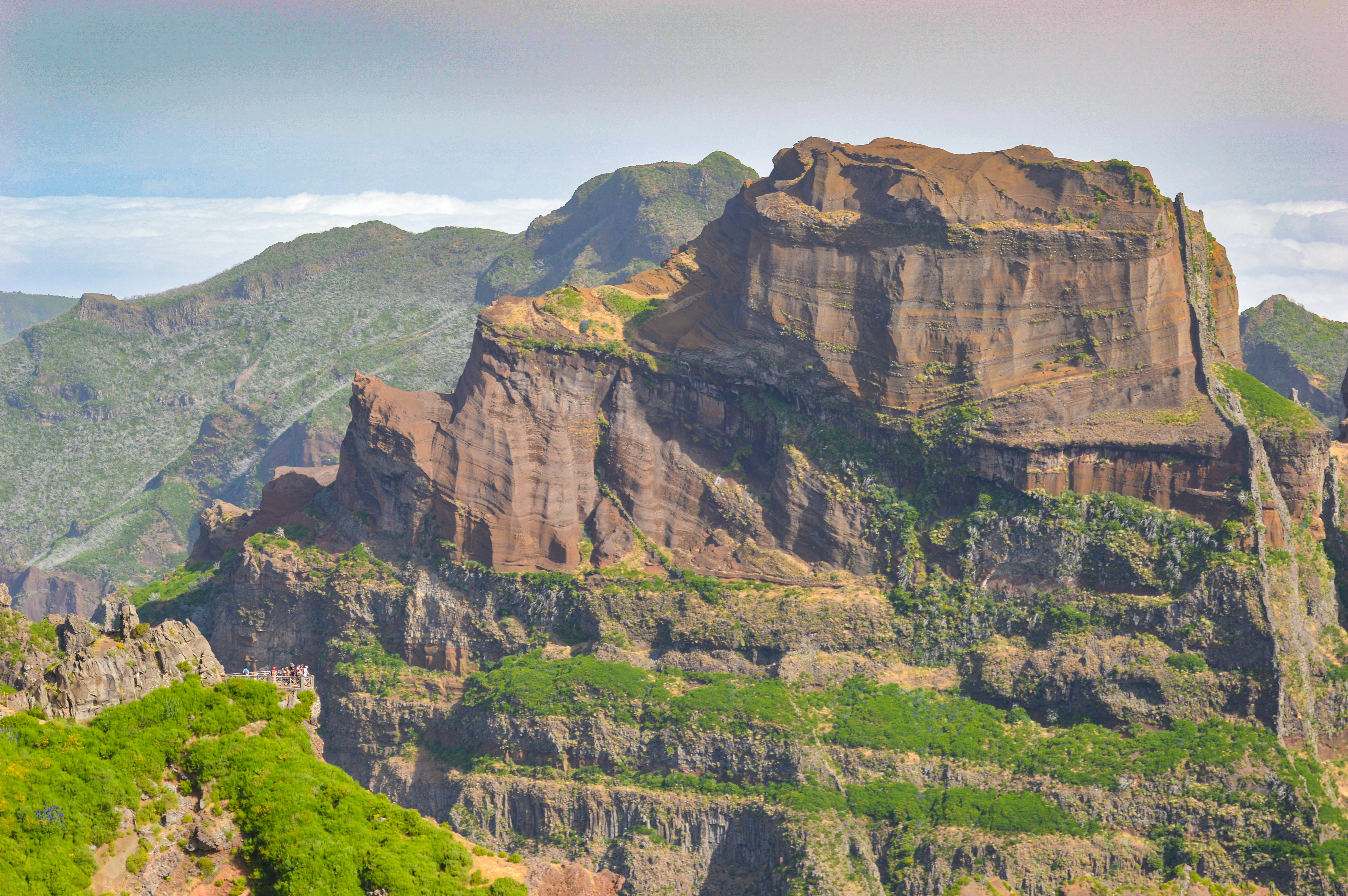 rugged, mountainous landscape with steep cliffs and rocky outcrops