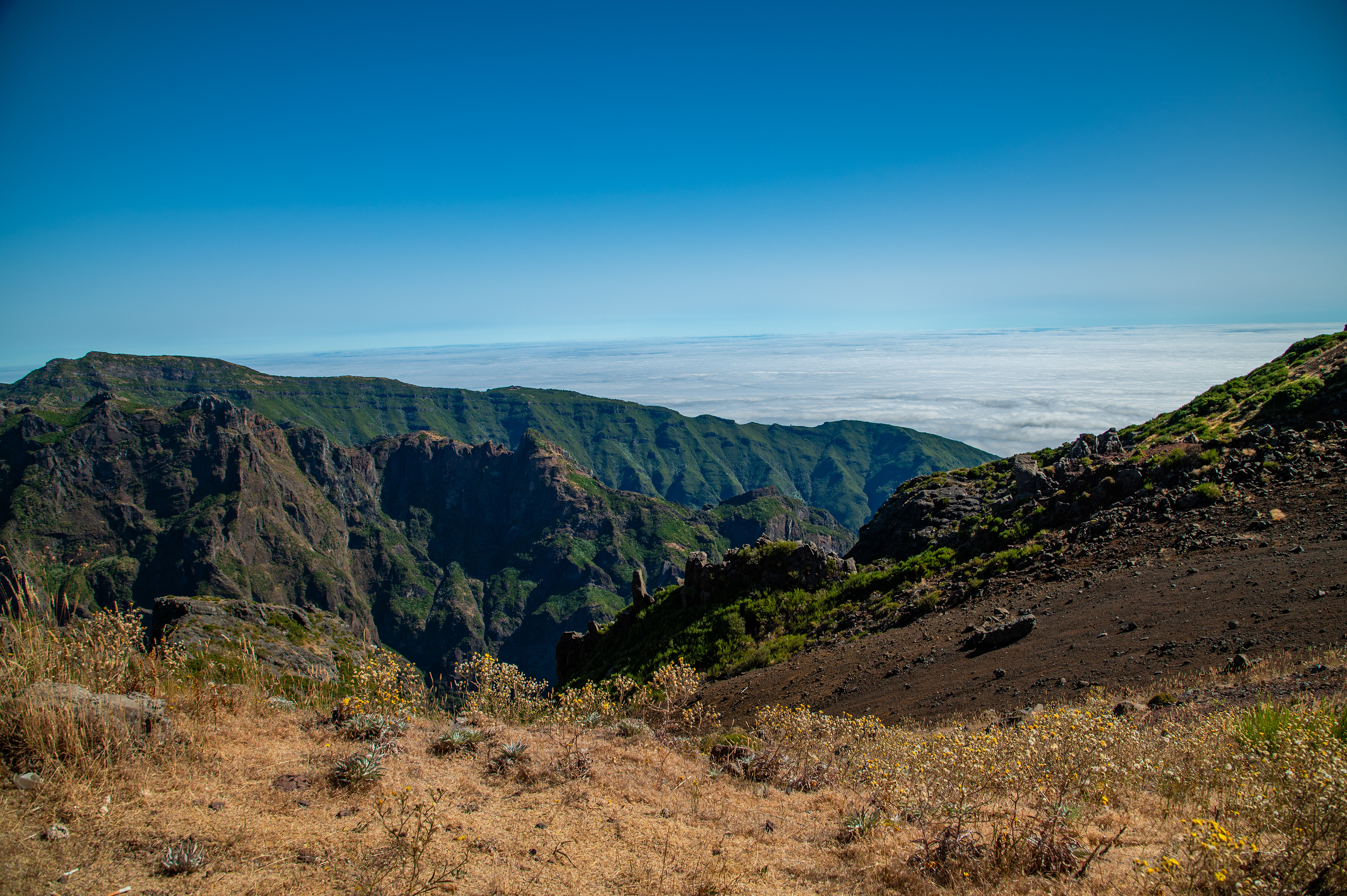 The scene is dominated by steep cliffs and valleys