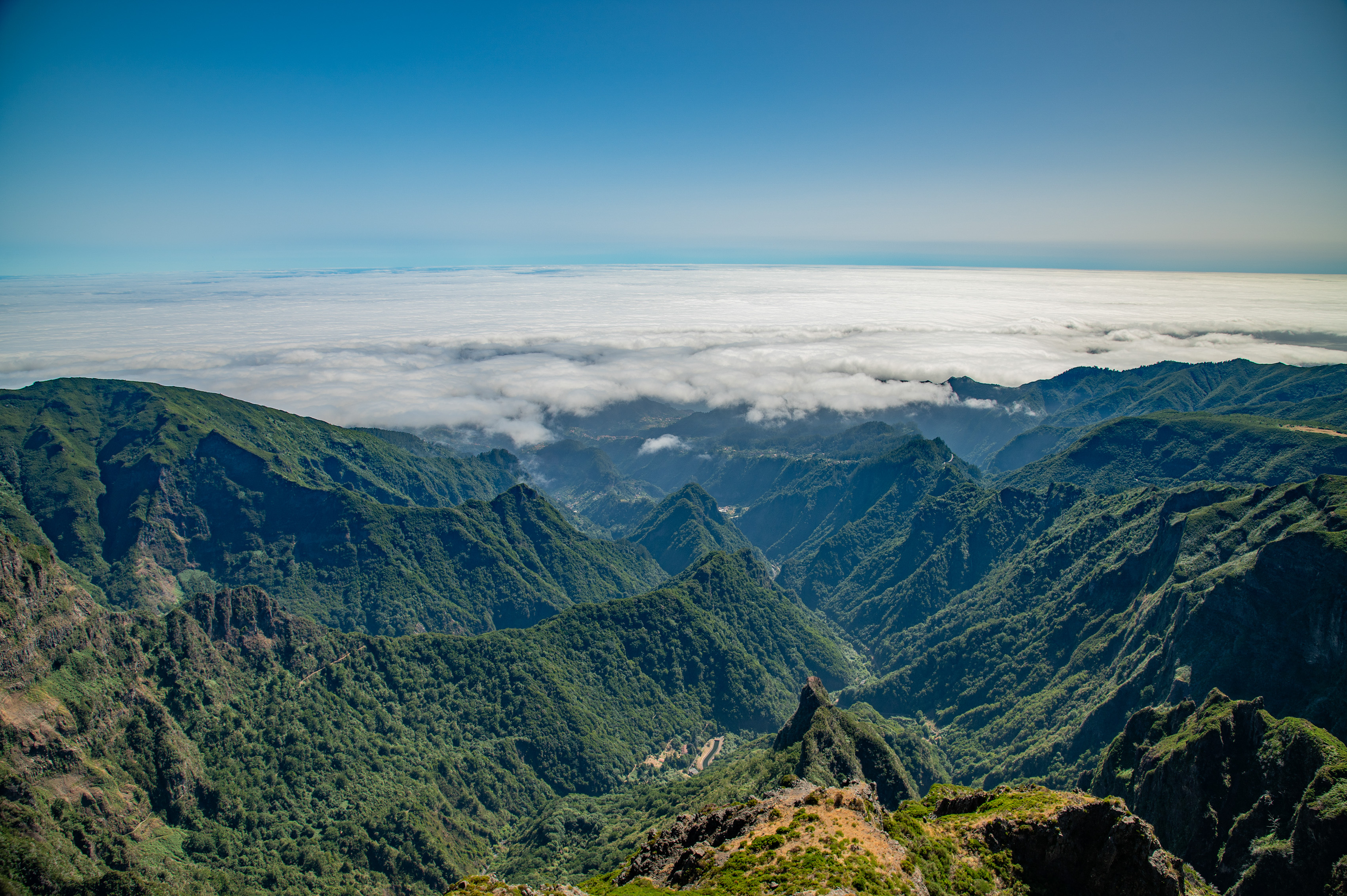 a sea of clouds below the mountain peaks