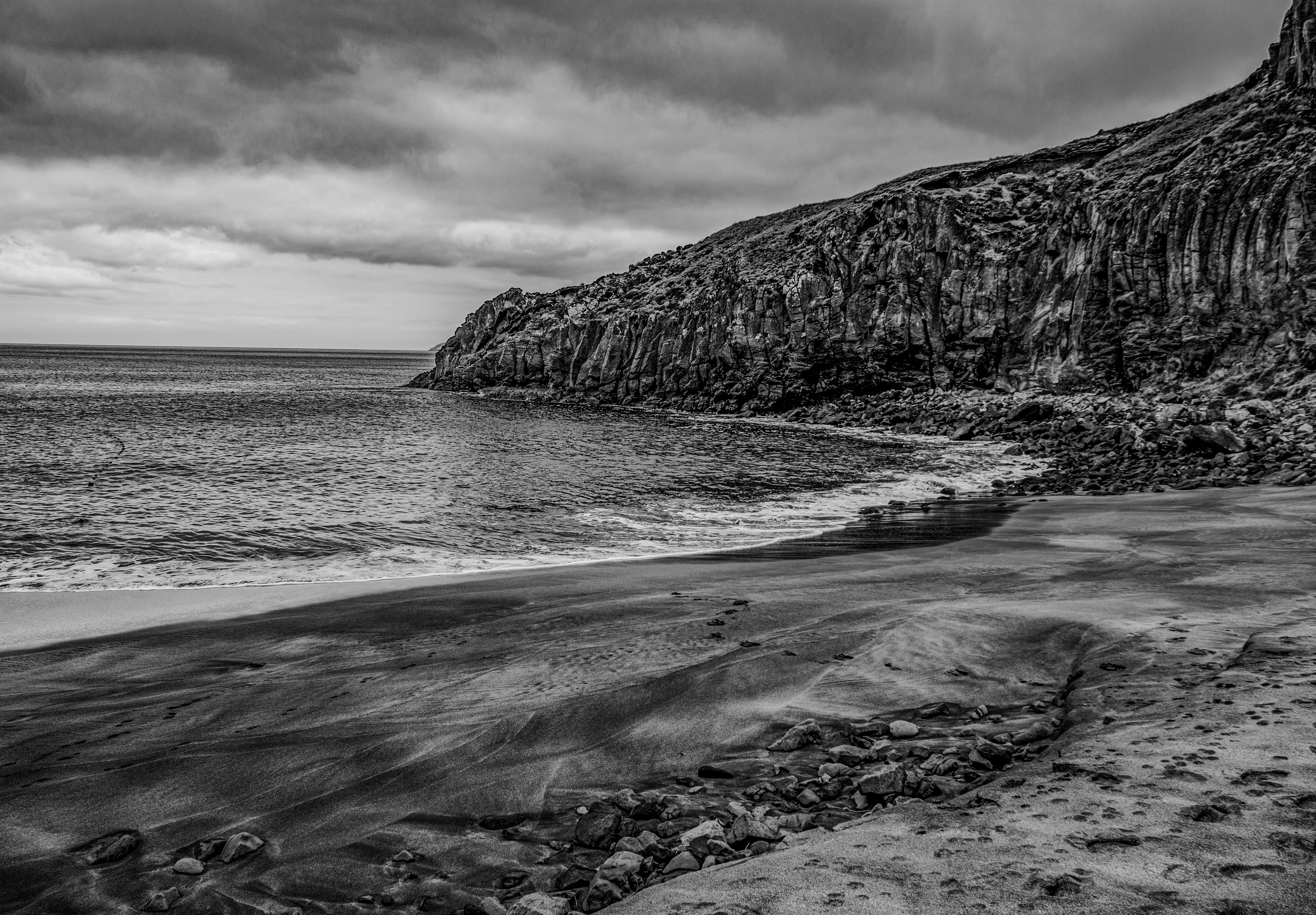 black and white photograph of a rocky beach
