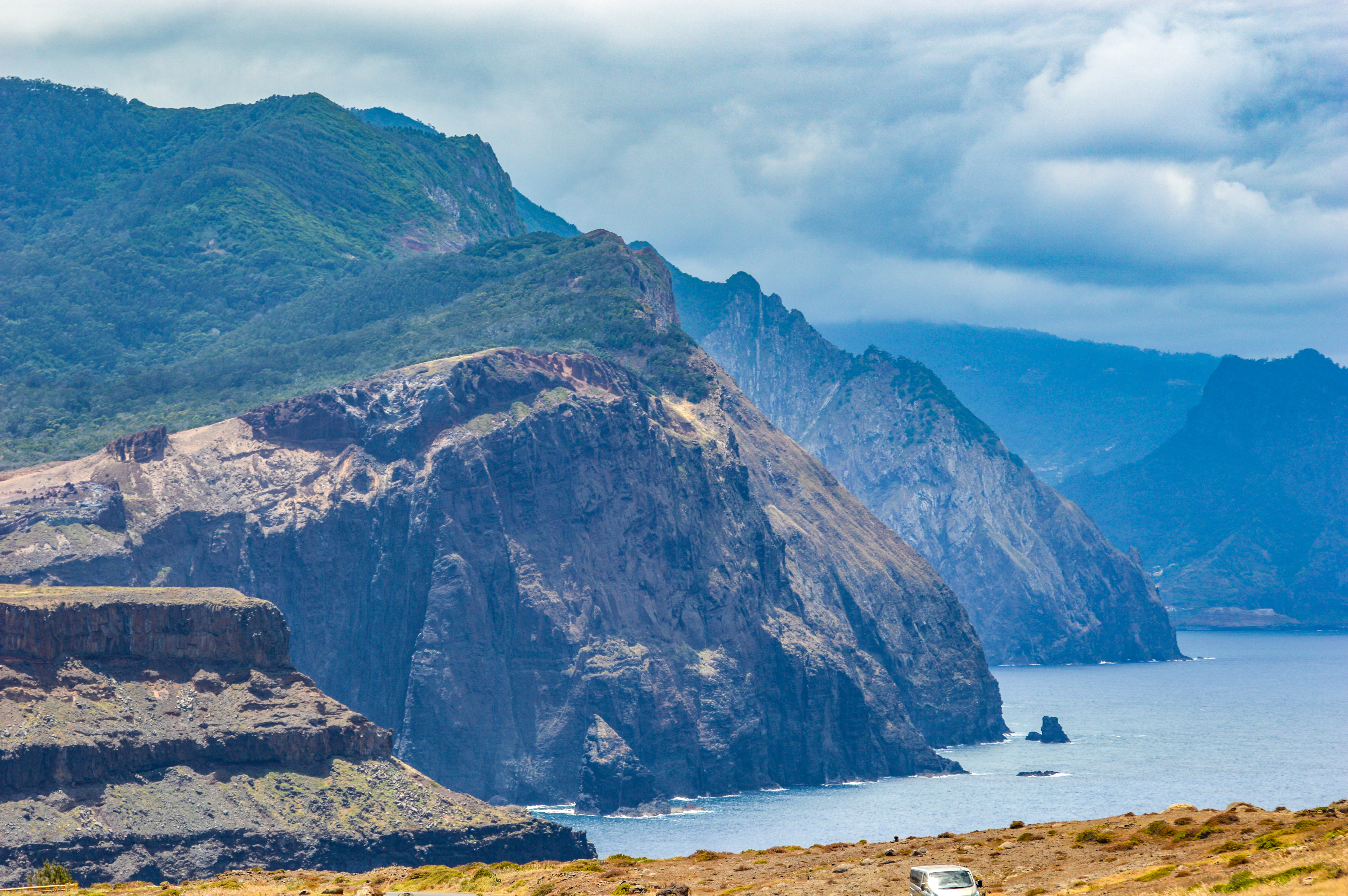 a rugged coastal landscape with steep cliffs