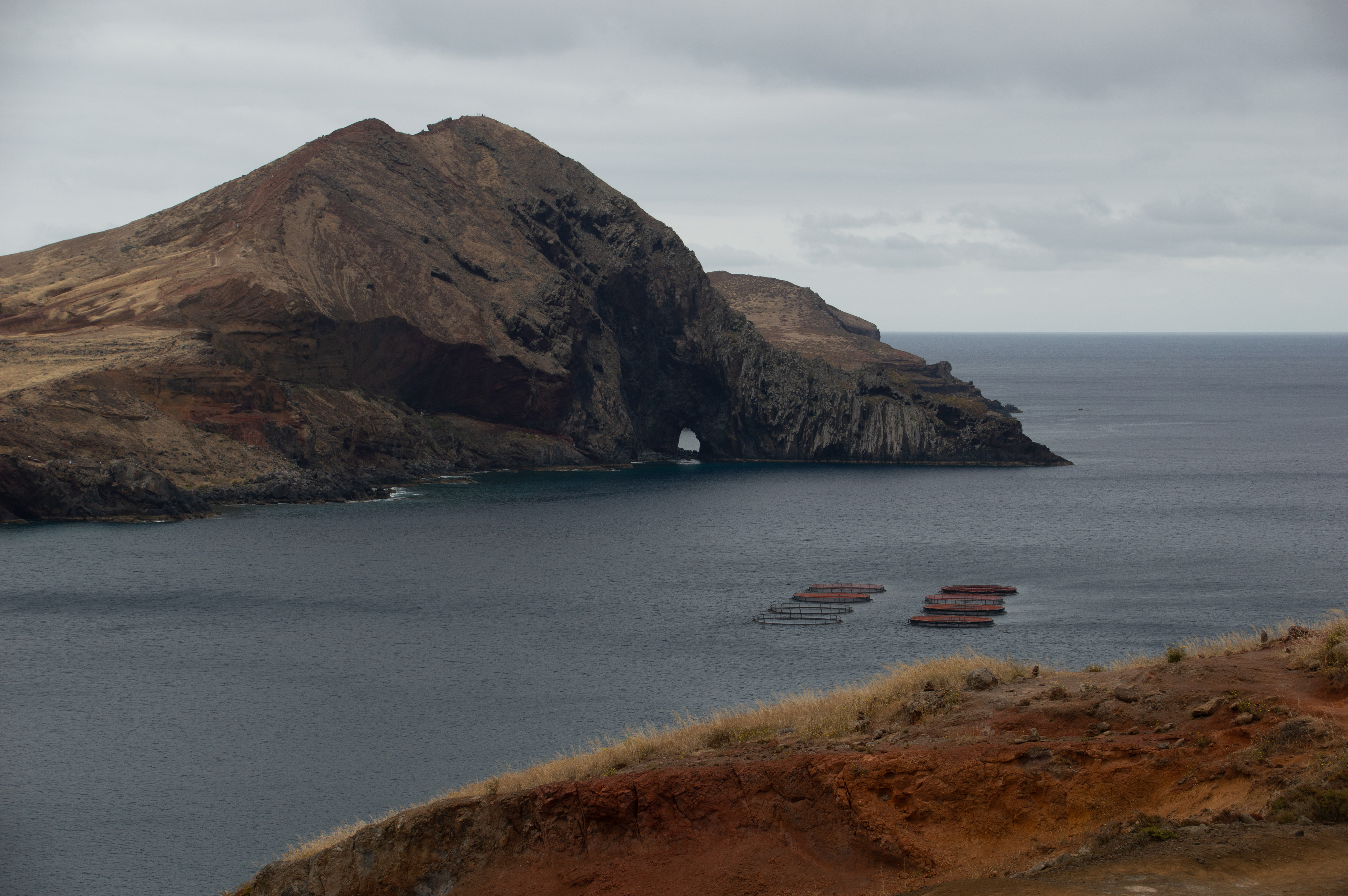 rugged cliff with a natural arch