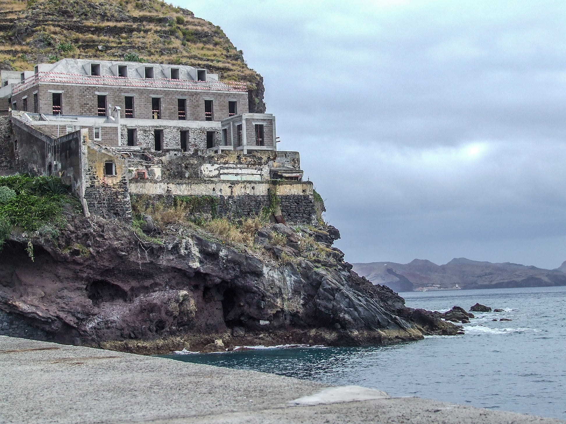 stone building situated on a cliff overlooking the sea