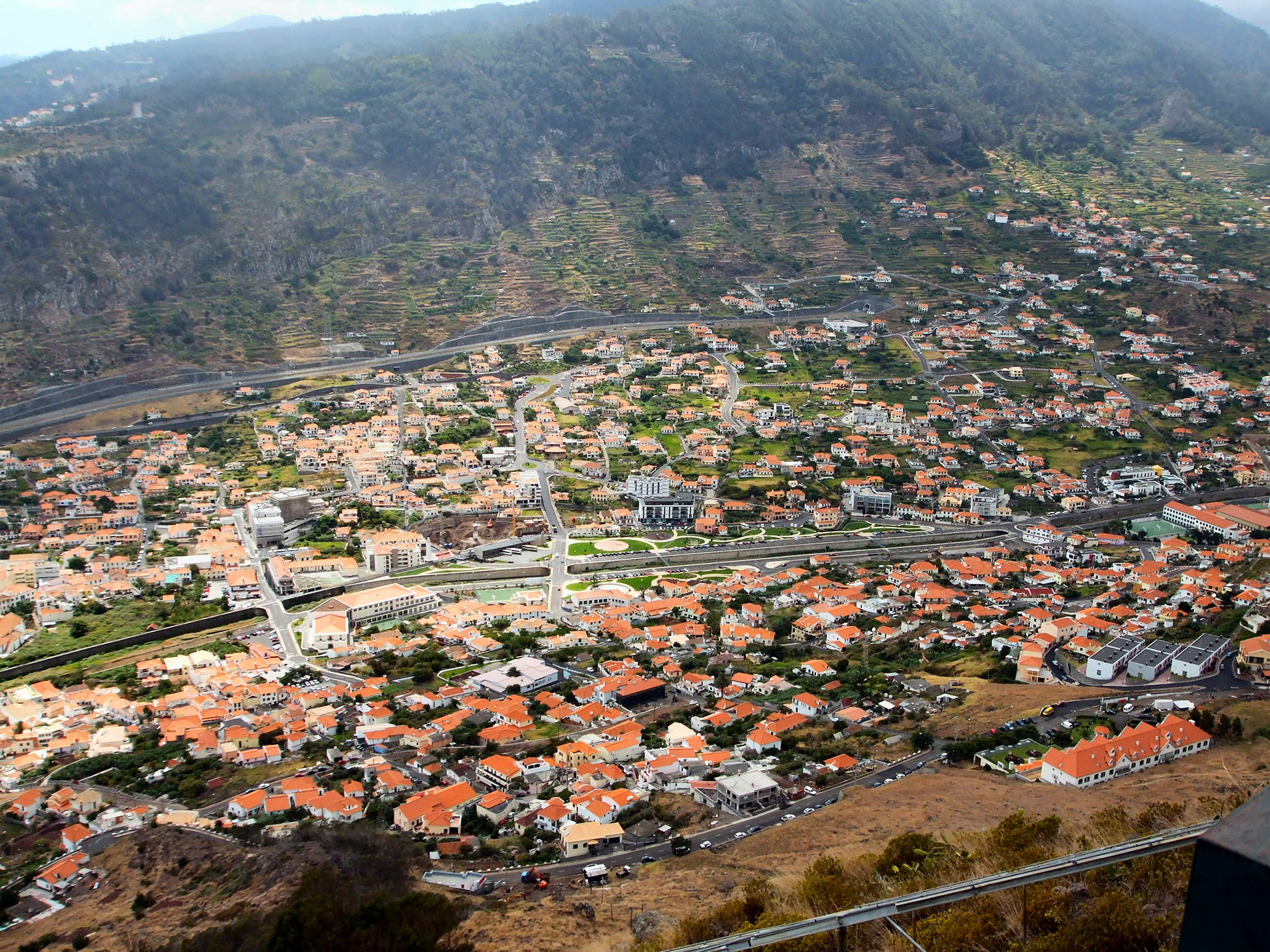 dense cluster of houses with red-tiled roofs