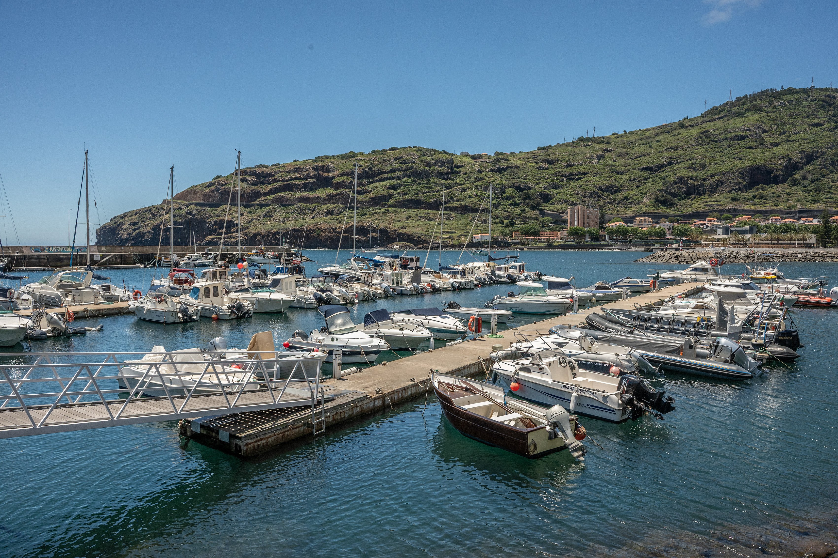 boats and yachts docked at piers
