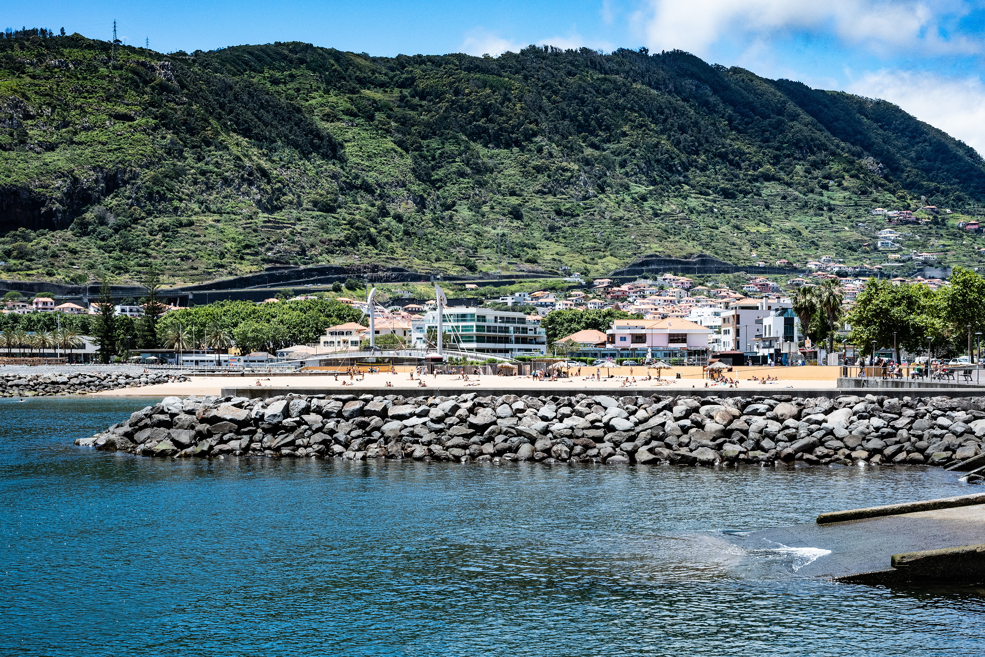 a beach with a breakwater made of large rocks