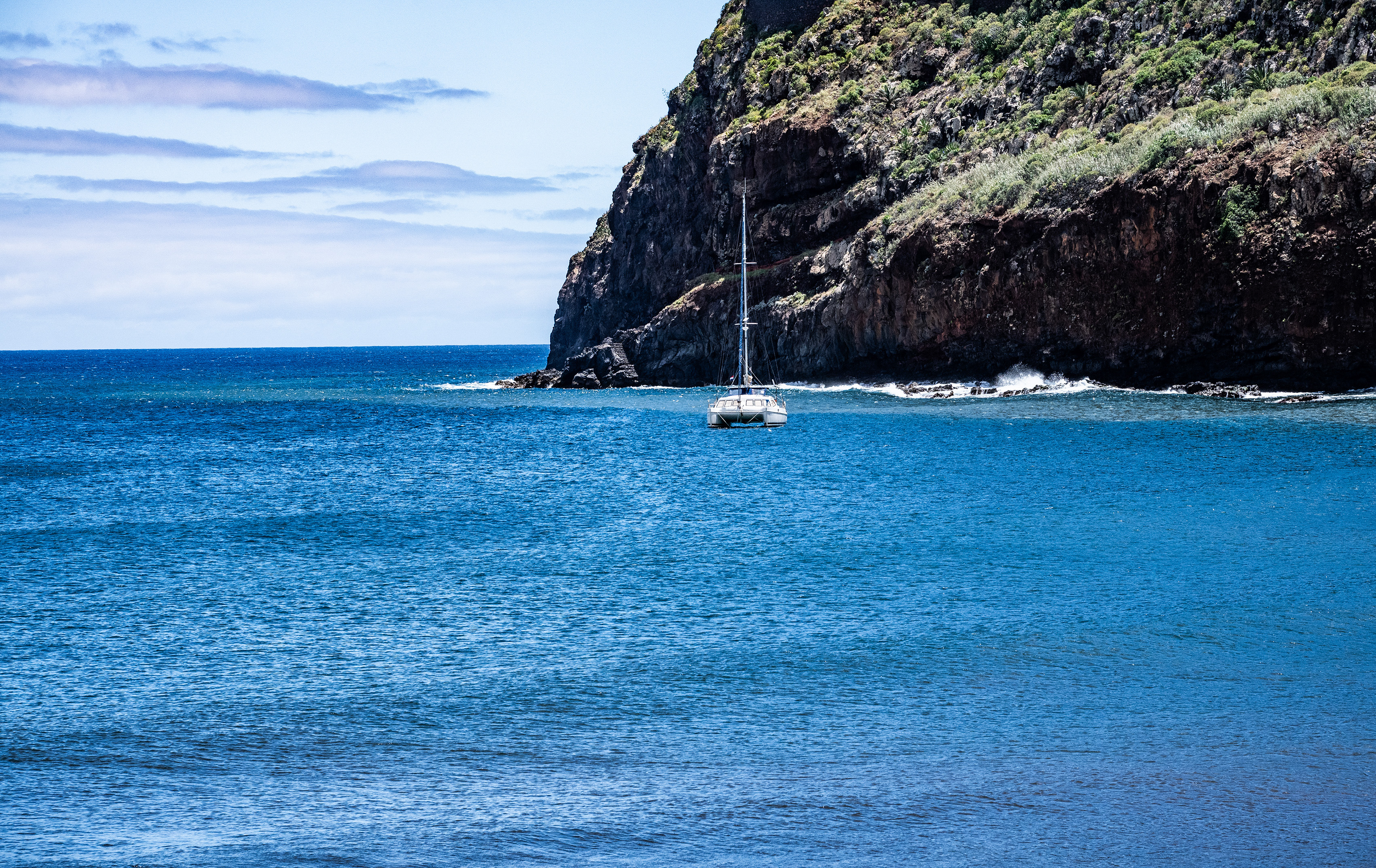 A pedestrian bridge extends over the water, connecting different parts of the marina