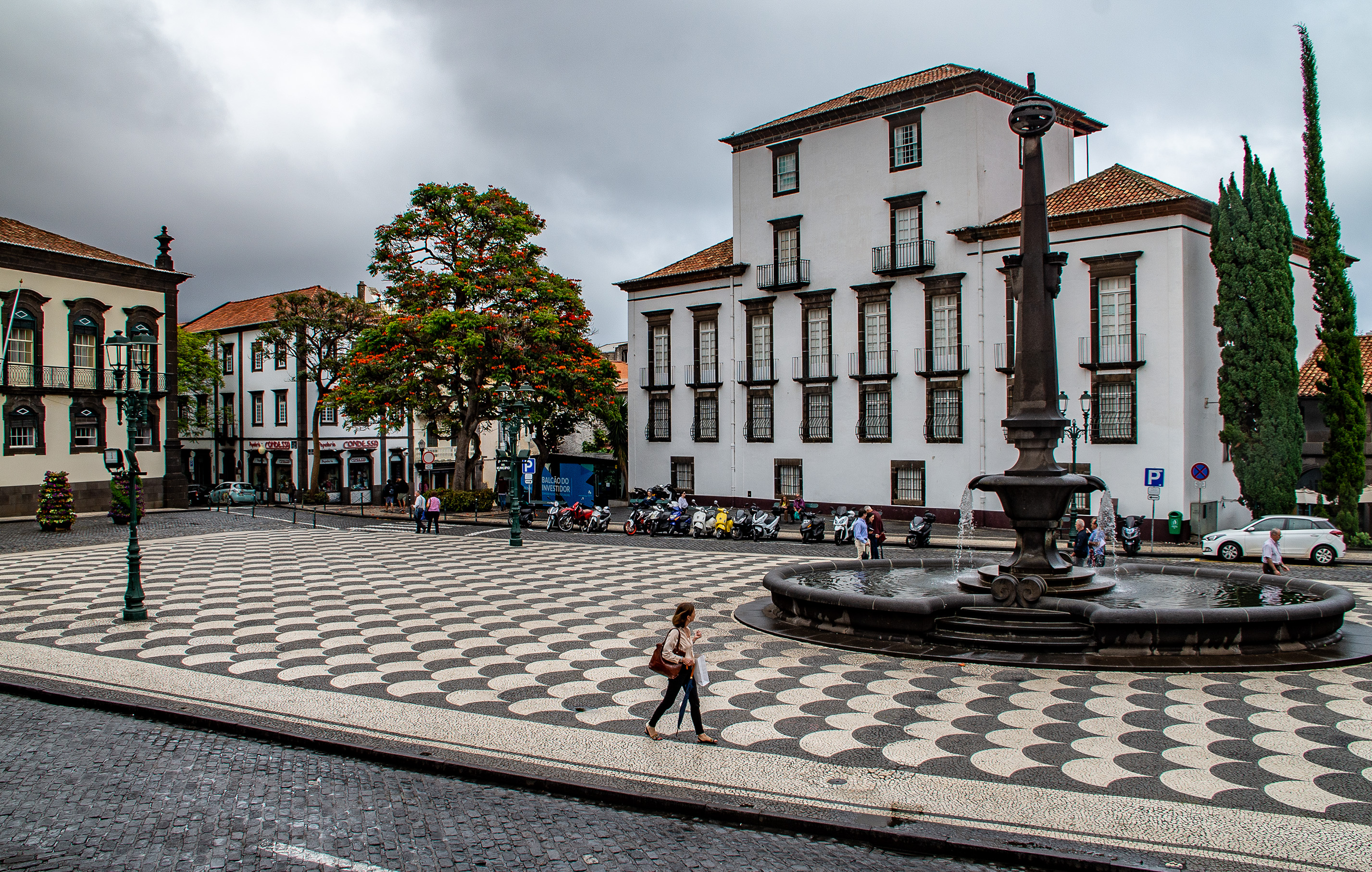 town square with a large, ornate fountain at its center.