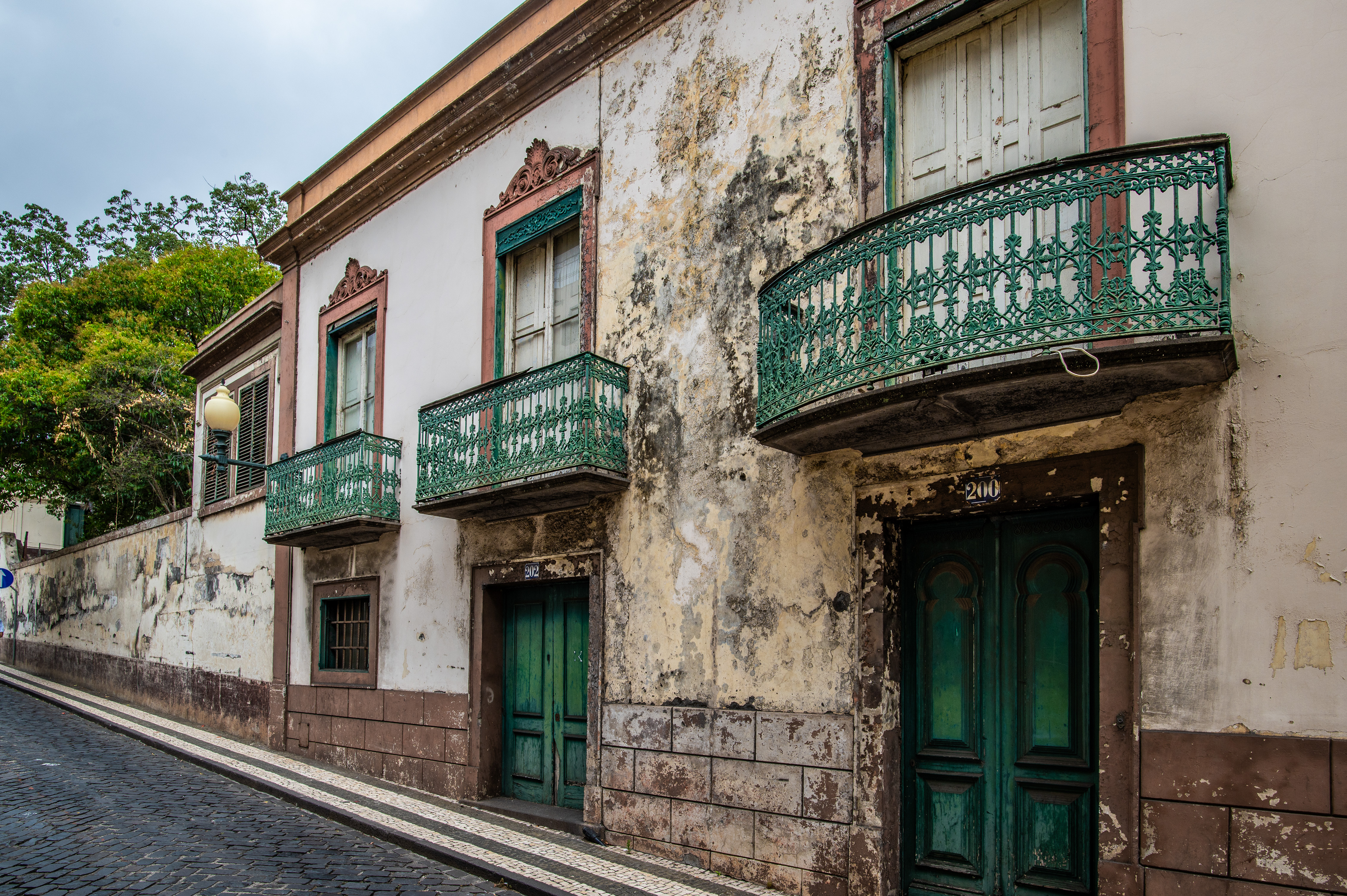 iron balconies and green shutters