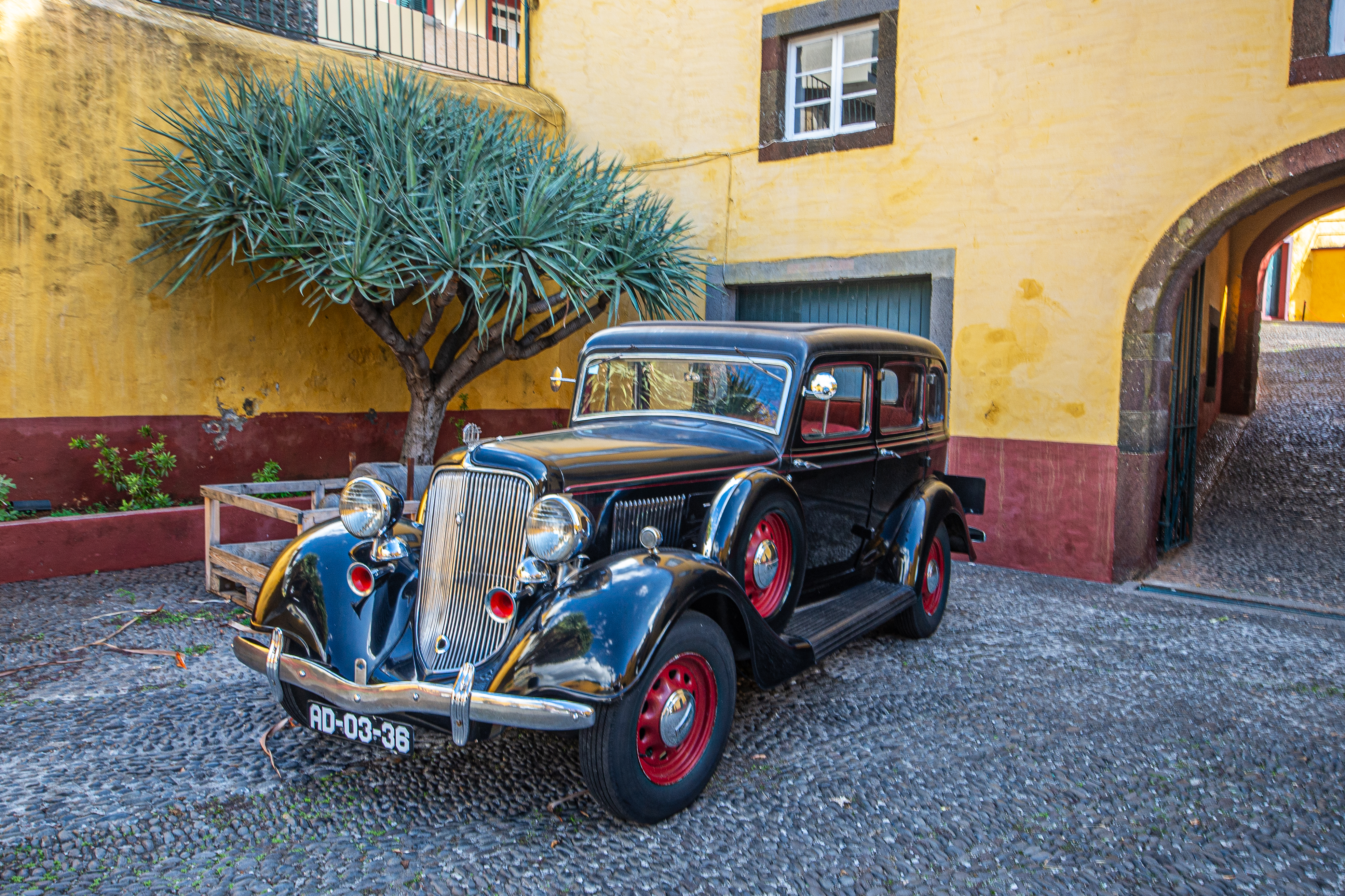 vintage car parked in a courtyard