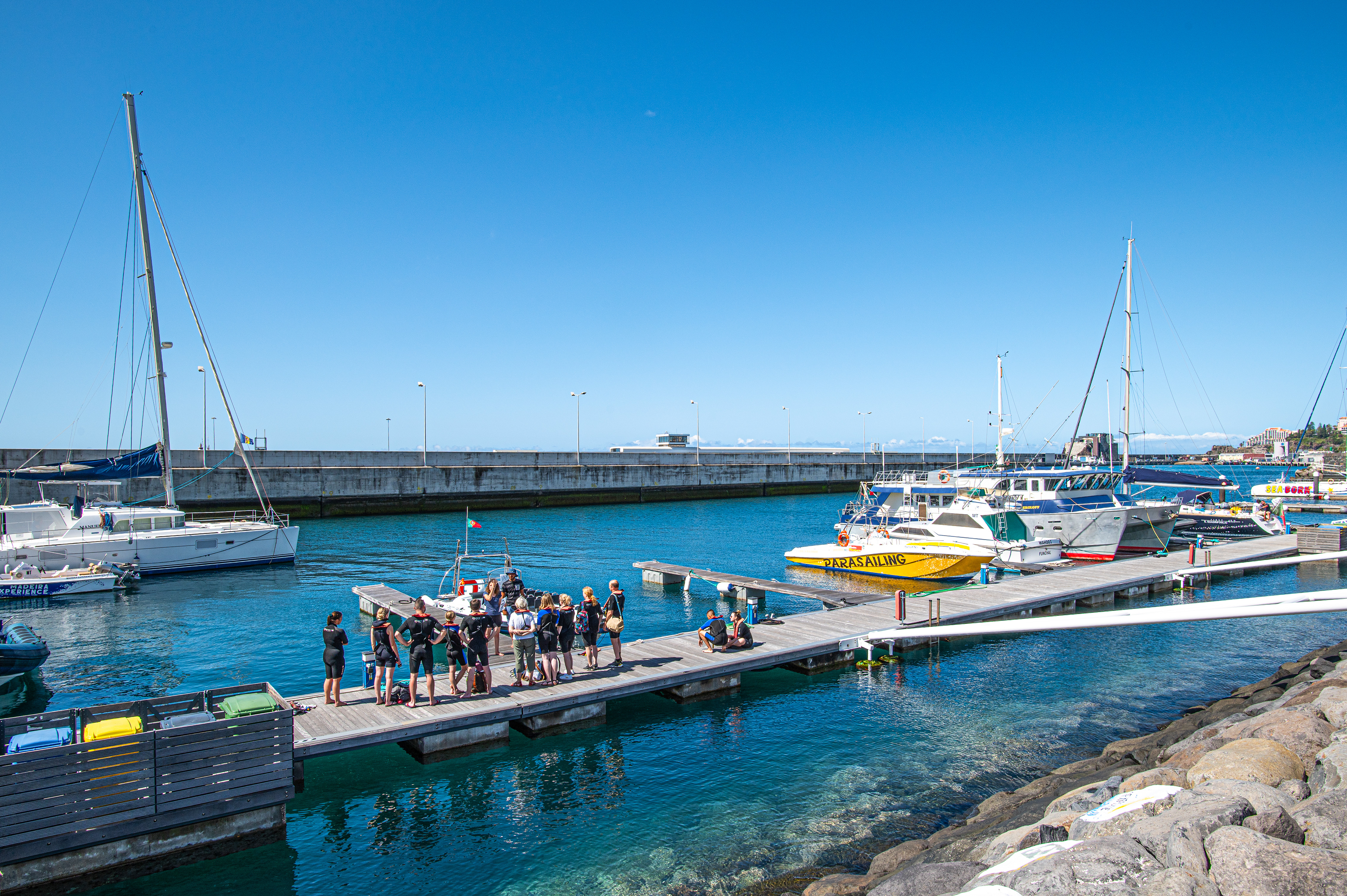 people gathered on a wooden pier