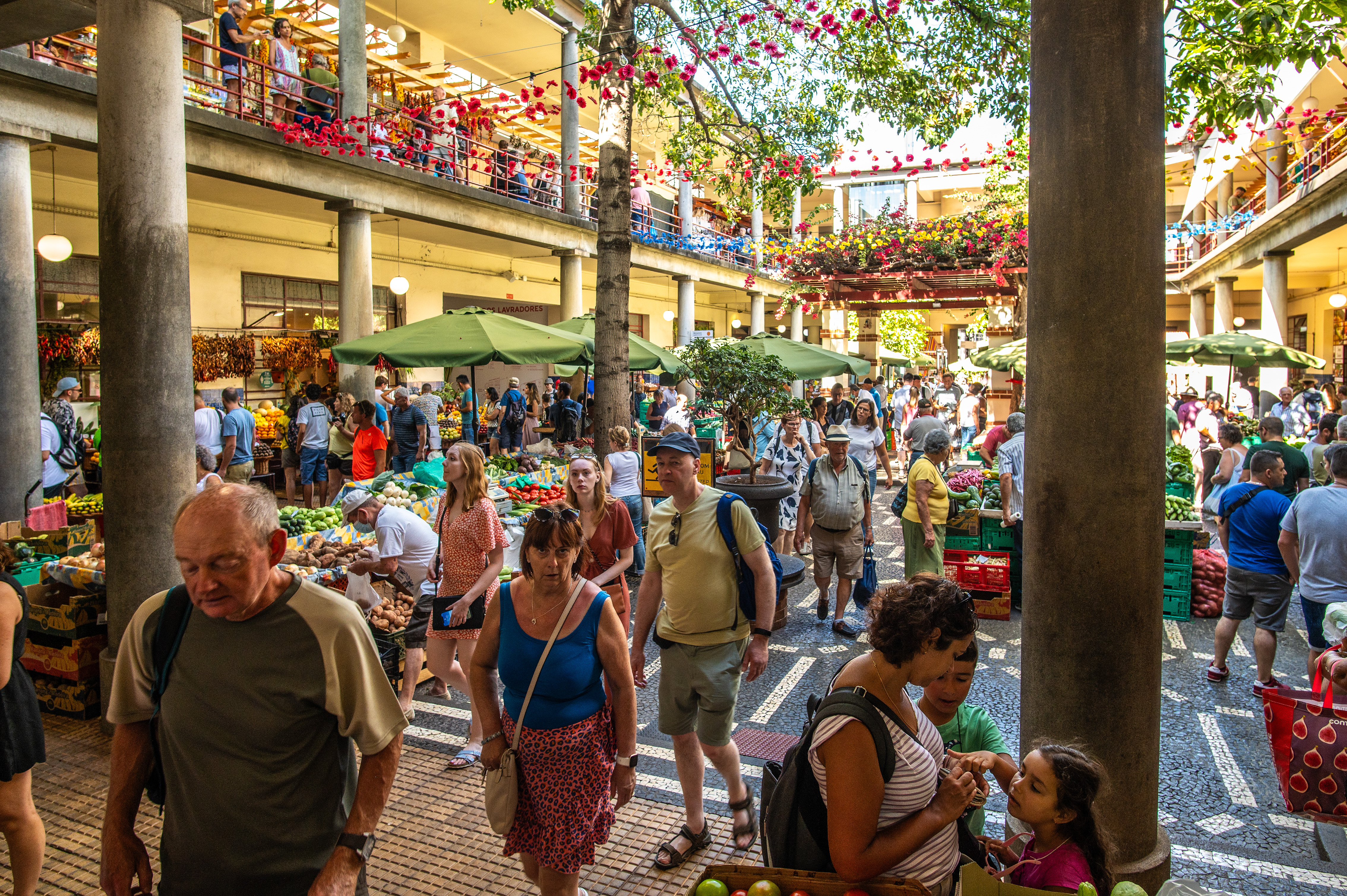 open-air environment with stalls selling a variety of fruits and vegetables