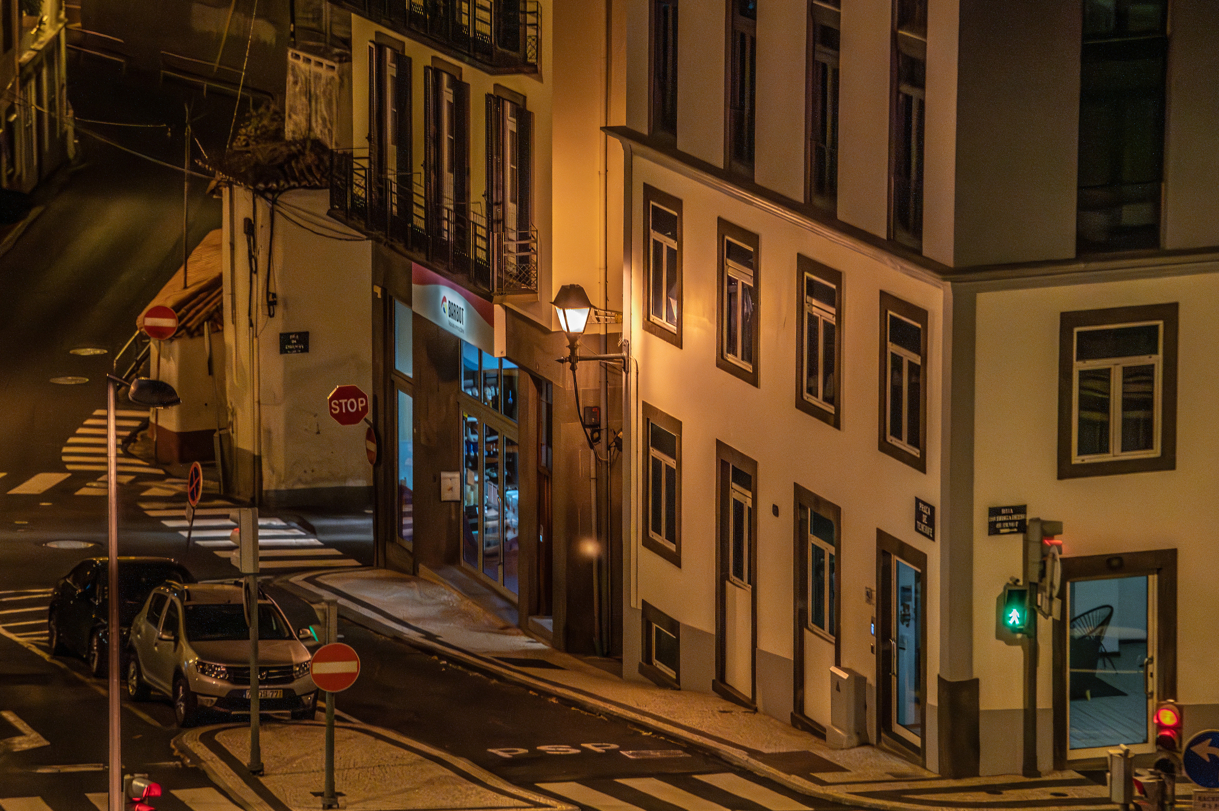 a corner building, illuminated by streetlights