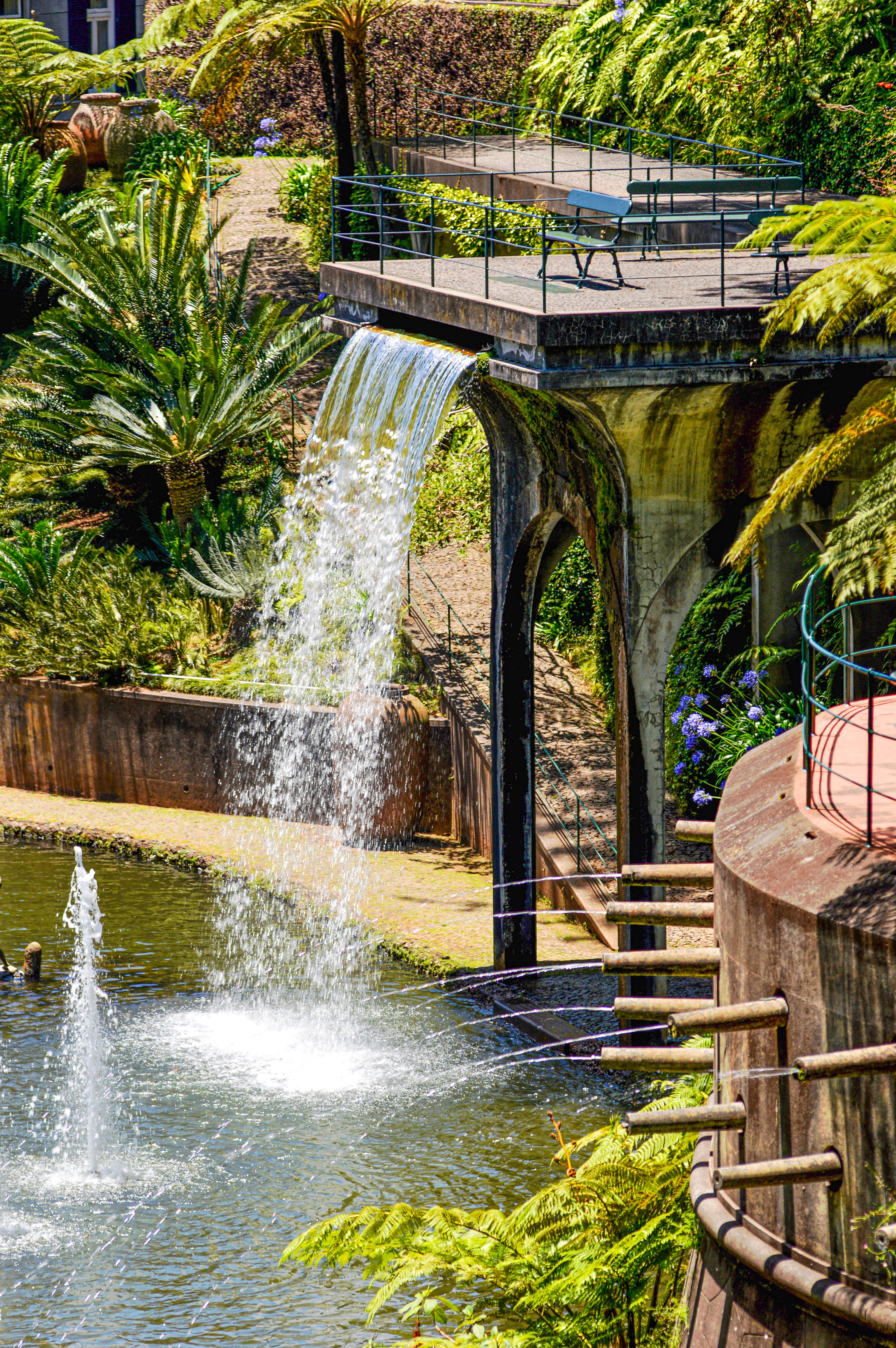 waterfall cascading over a stone structure into a pond