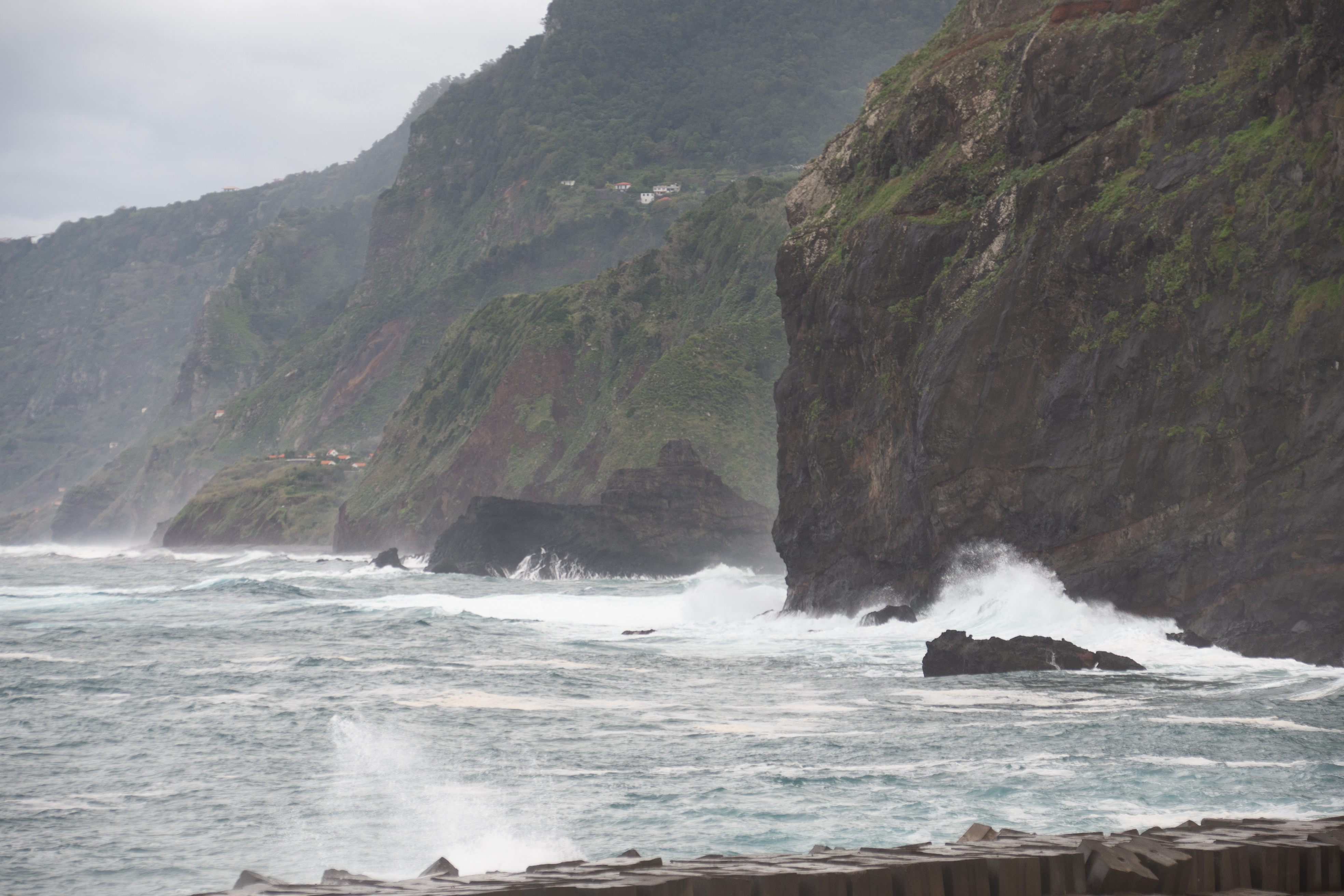 Waves are crashing against the cliffs and rocks