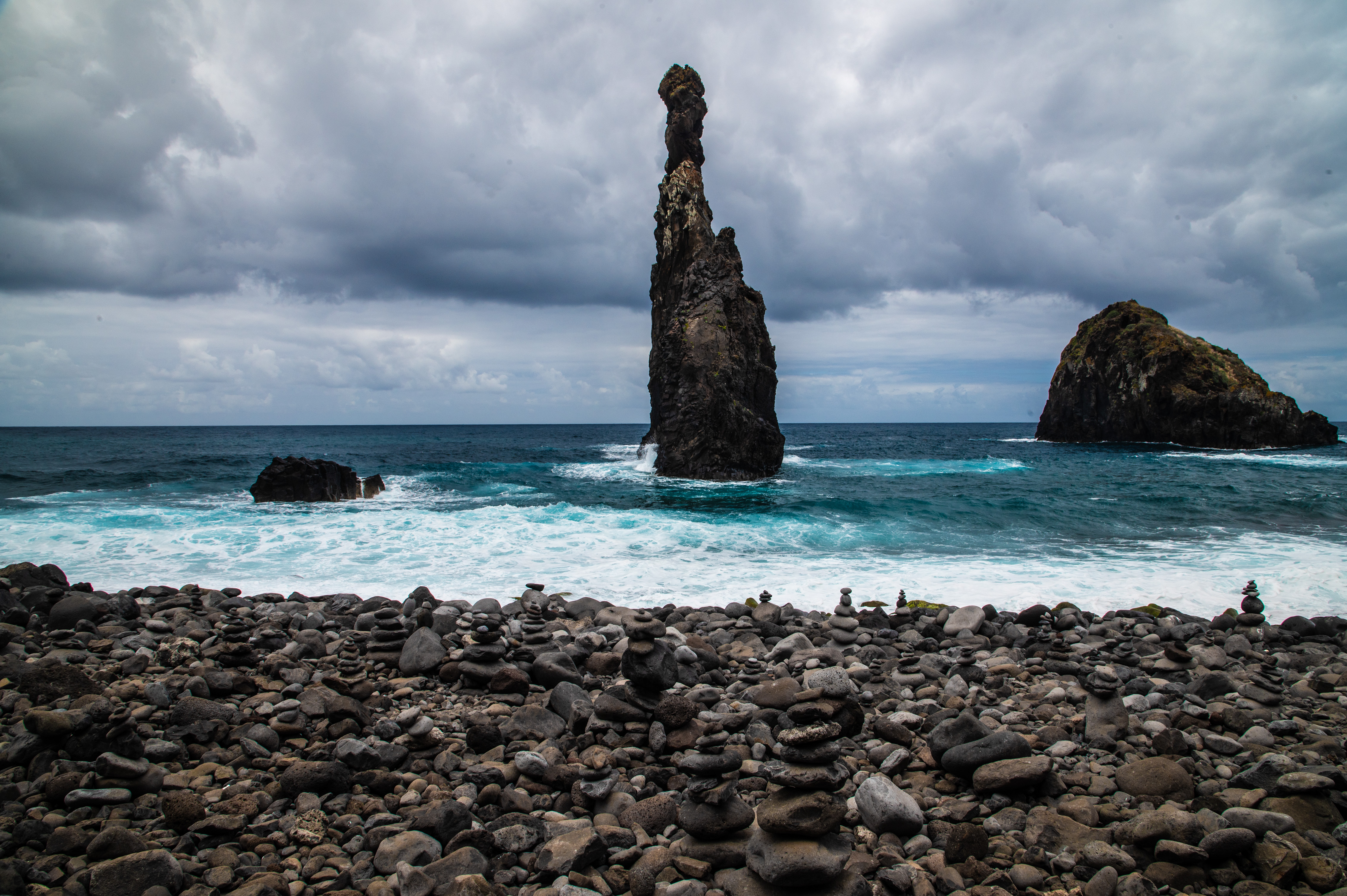 tall, narrow rock formation rising from the ocean