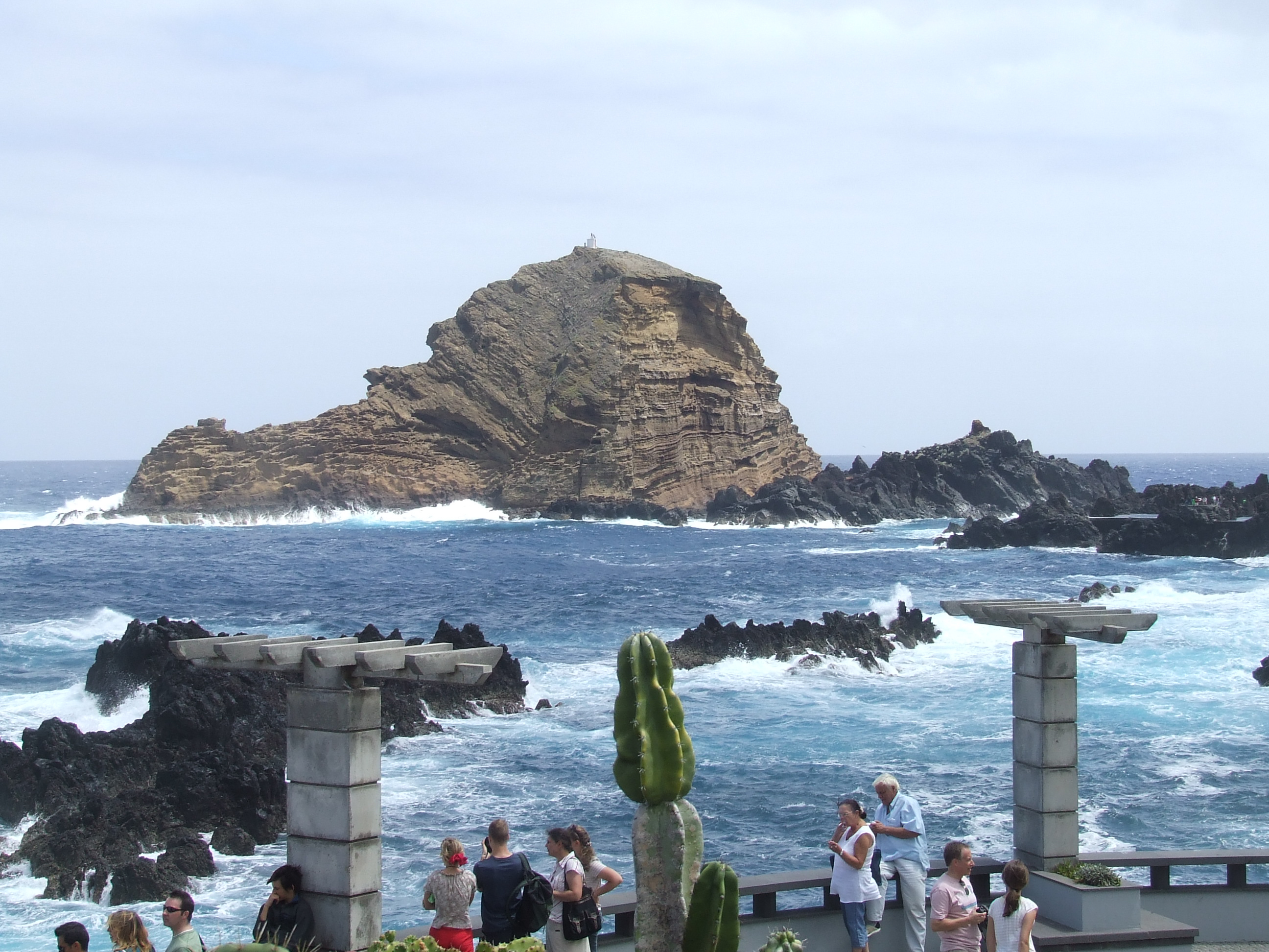 prominent rocky outcrop rising from the ocean