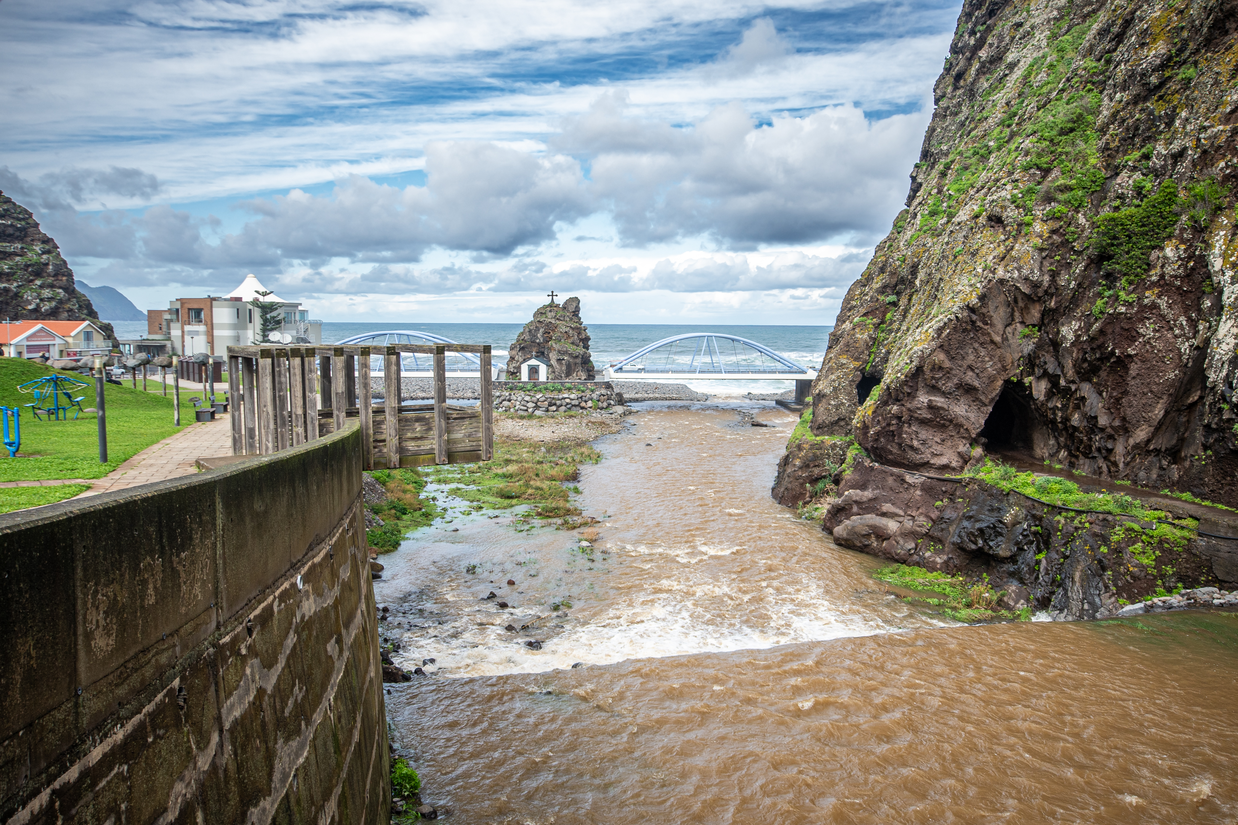 scenic coastal area with a river flowing towards the ocean