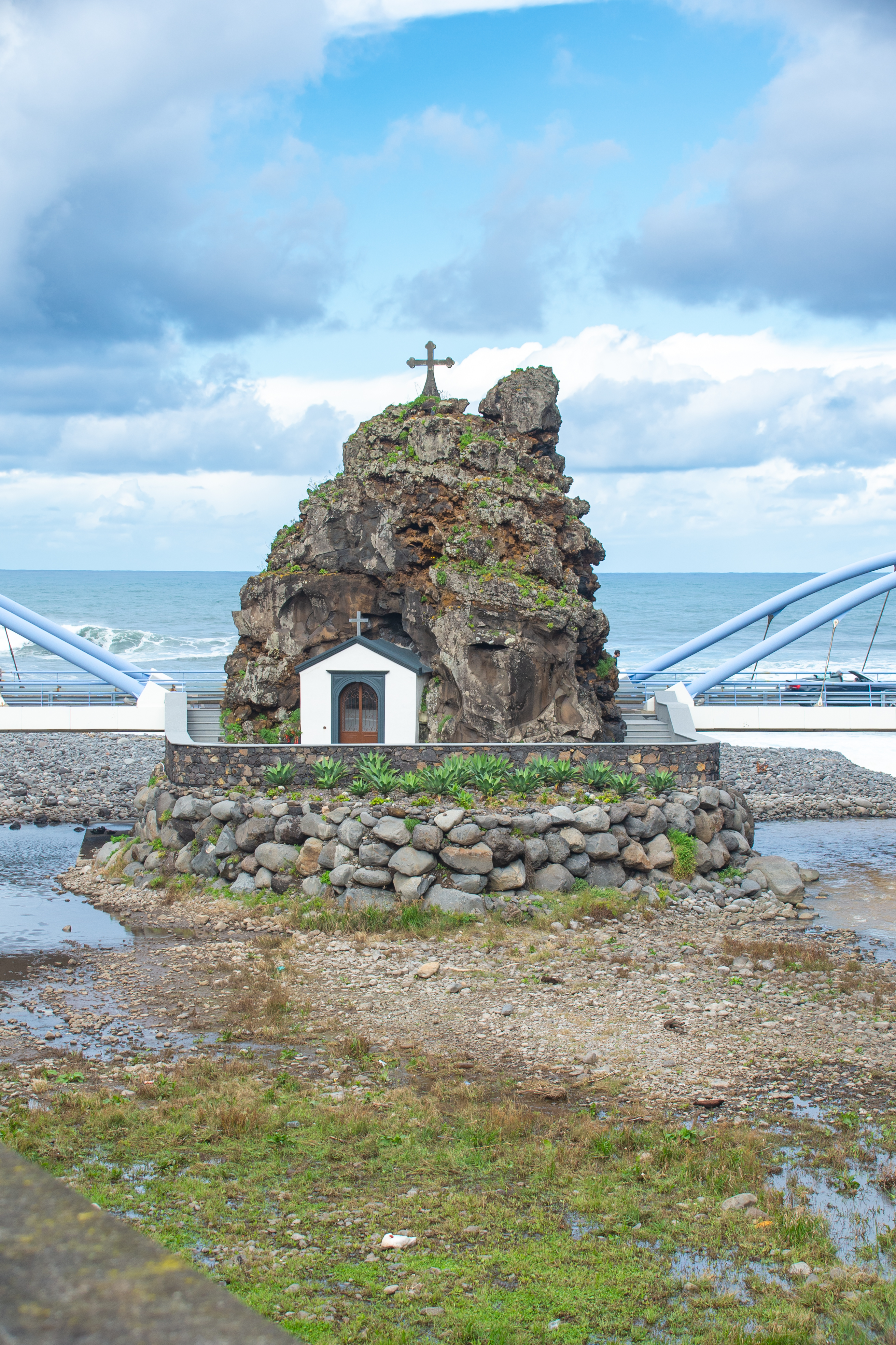 a small chapel built into a rocky outcrop near the sea
