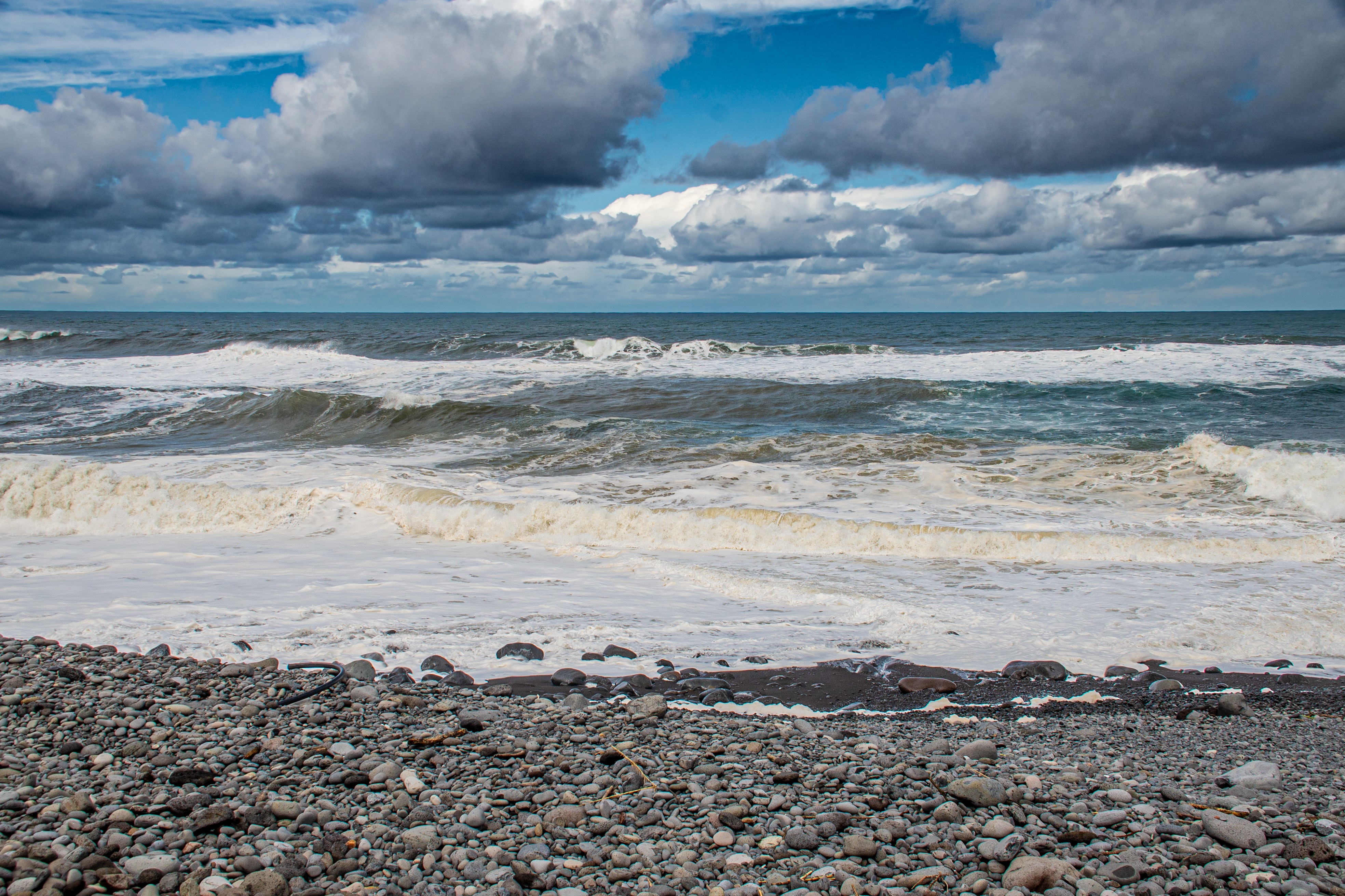 a rocky beach with waves crashing onto the shore