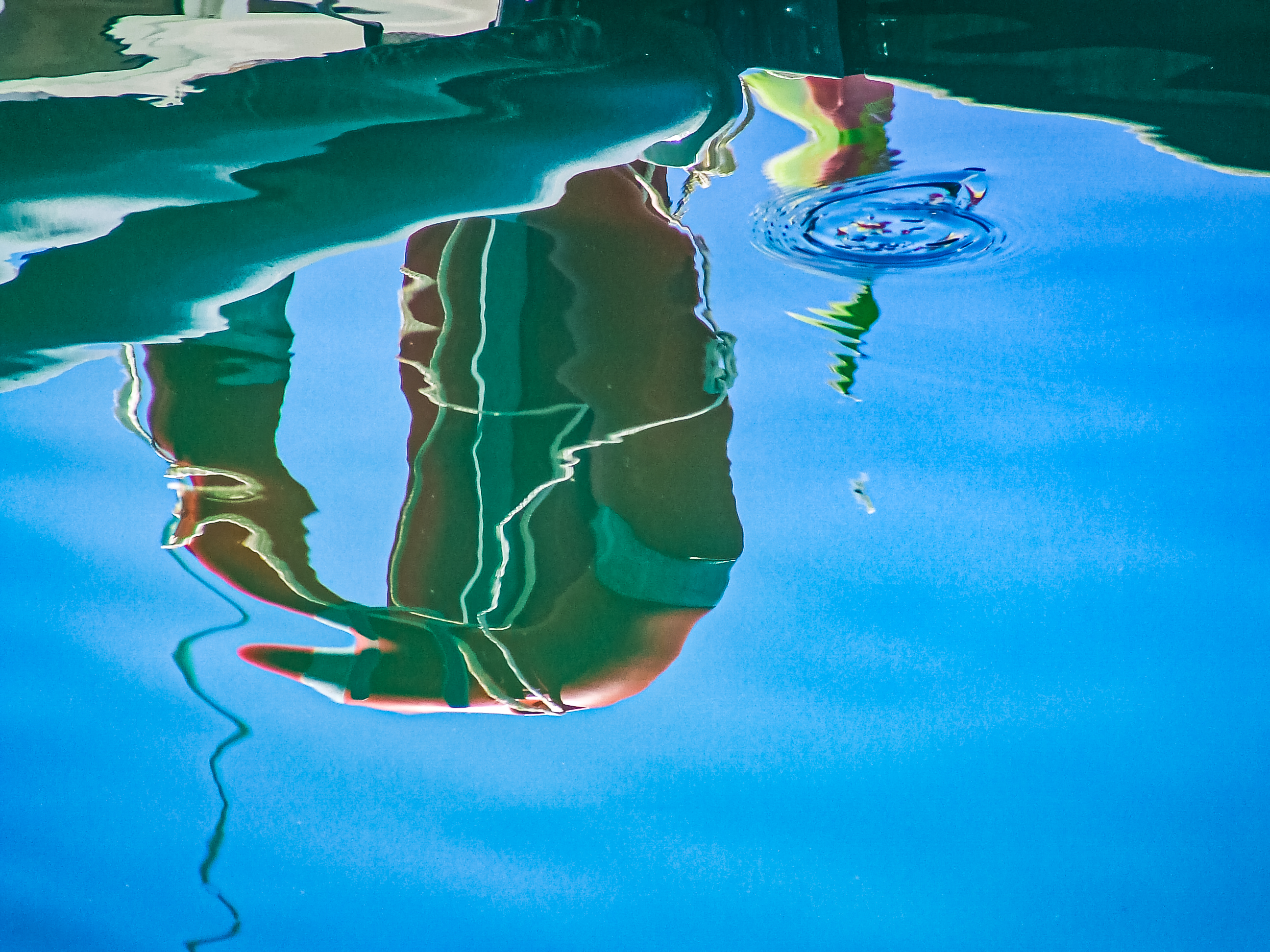 a reflection distorted by ripples in the watert