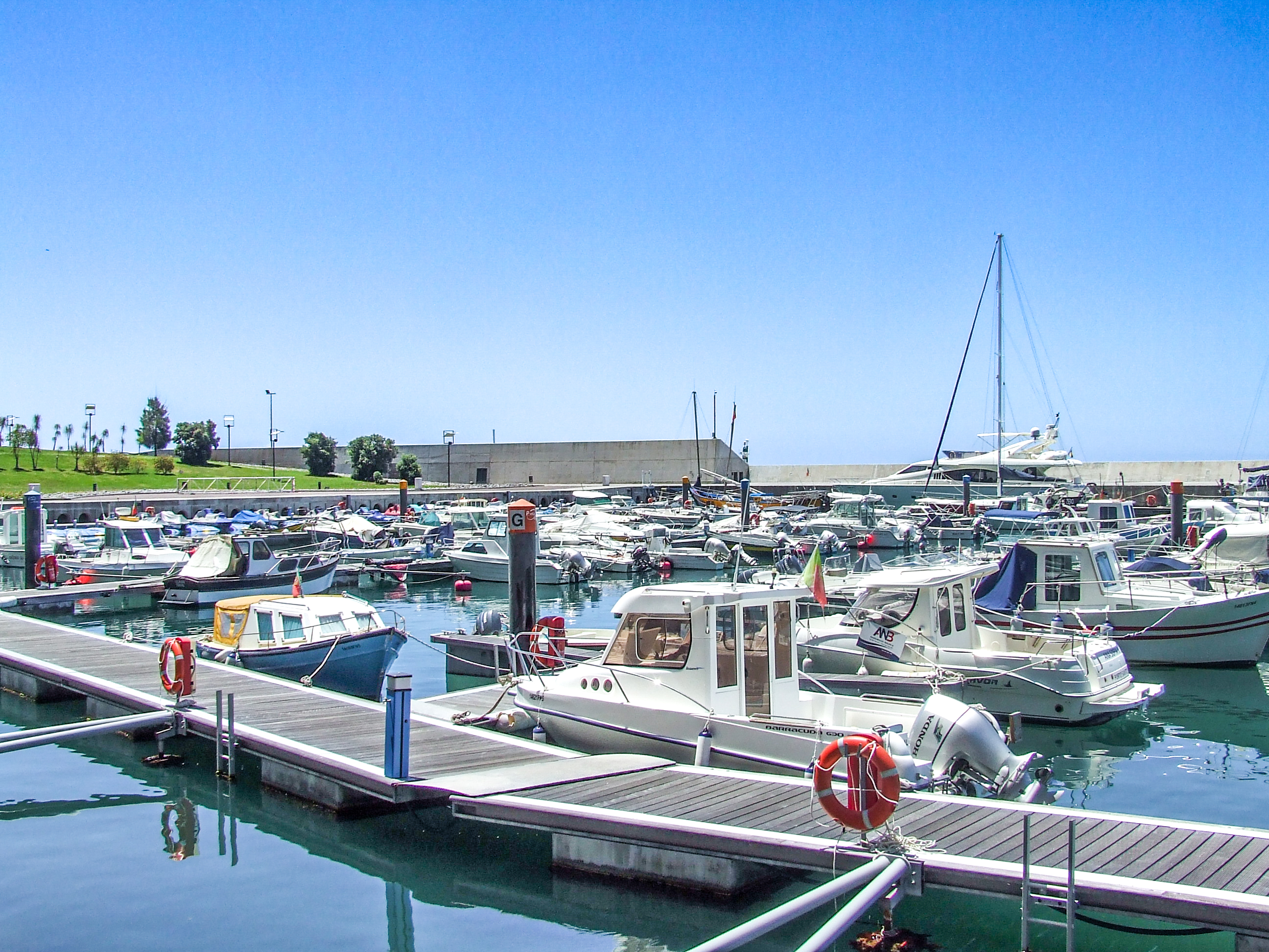 boats and yachts docked at wooden piers
