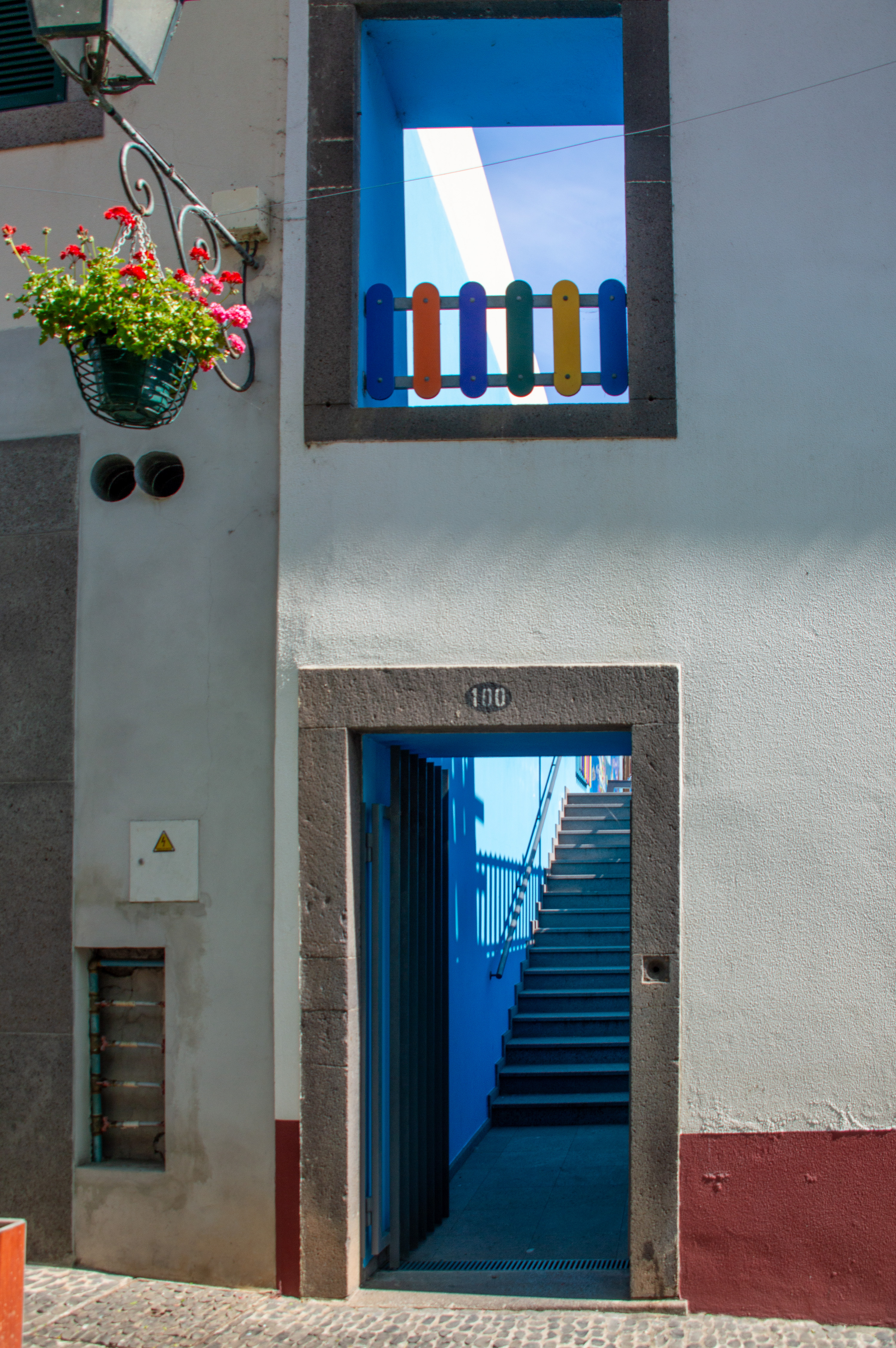 a window with a colorful, multicolored railing