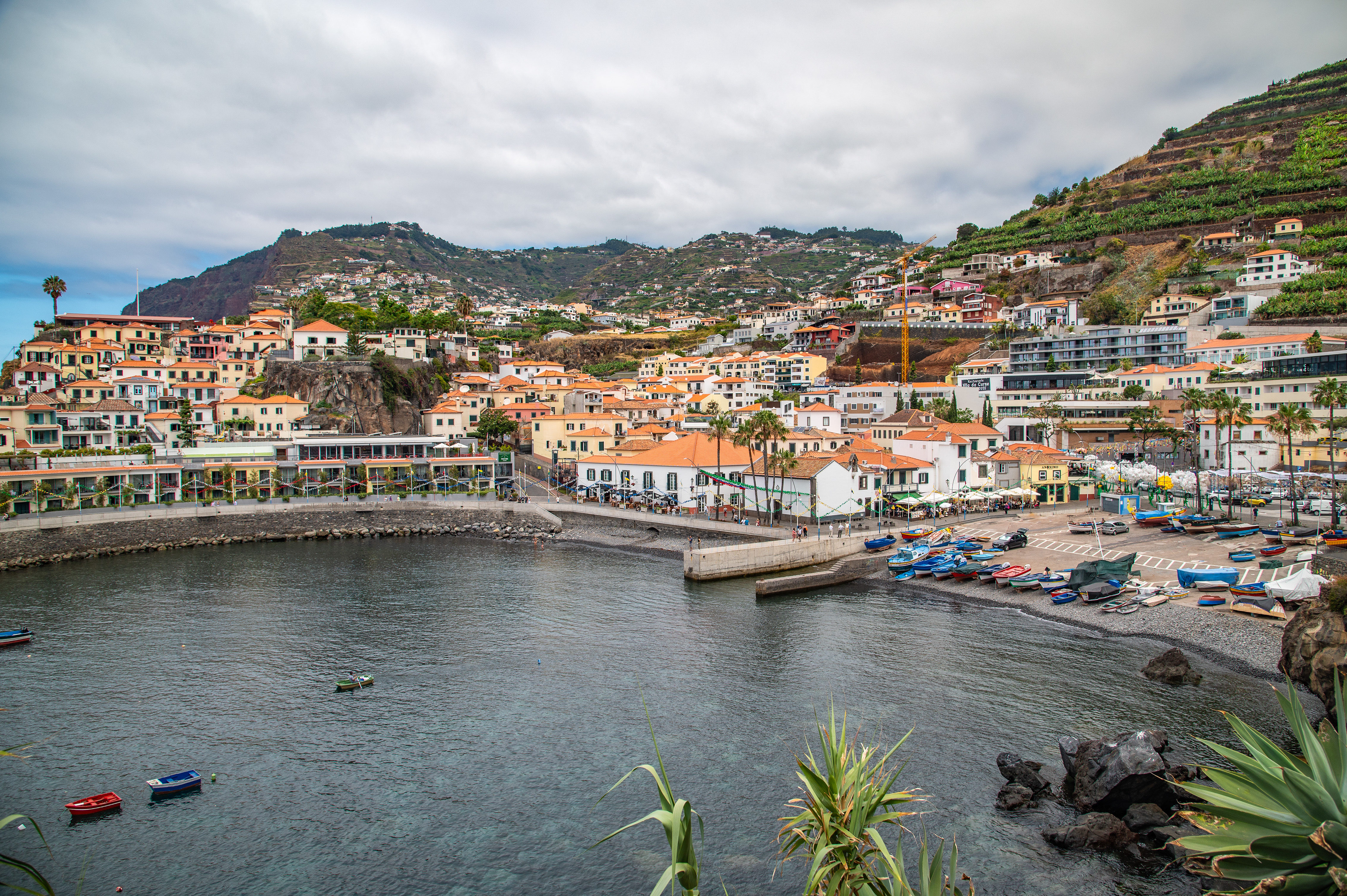 The harbor is lined with boats and surrounded by a rocky shore