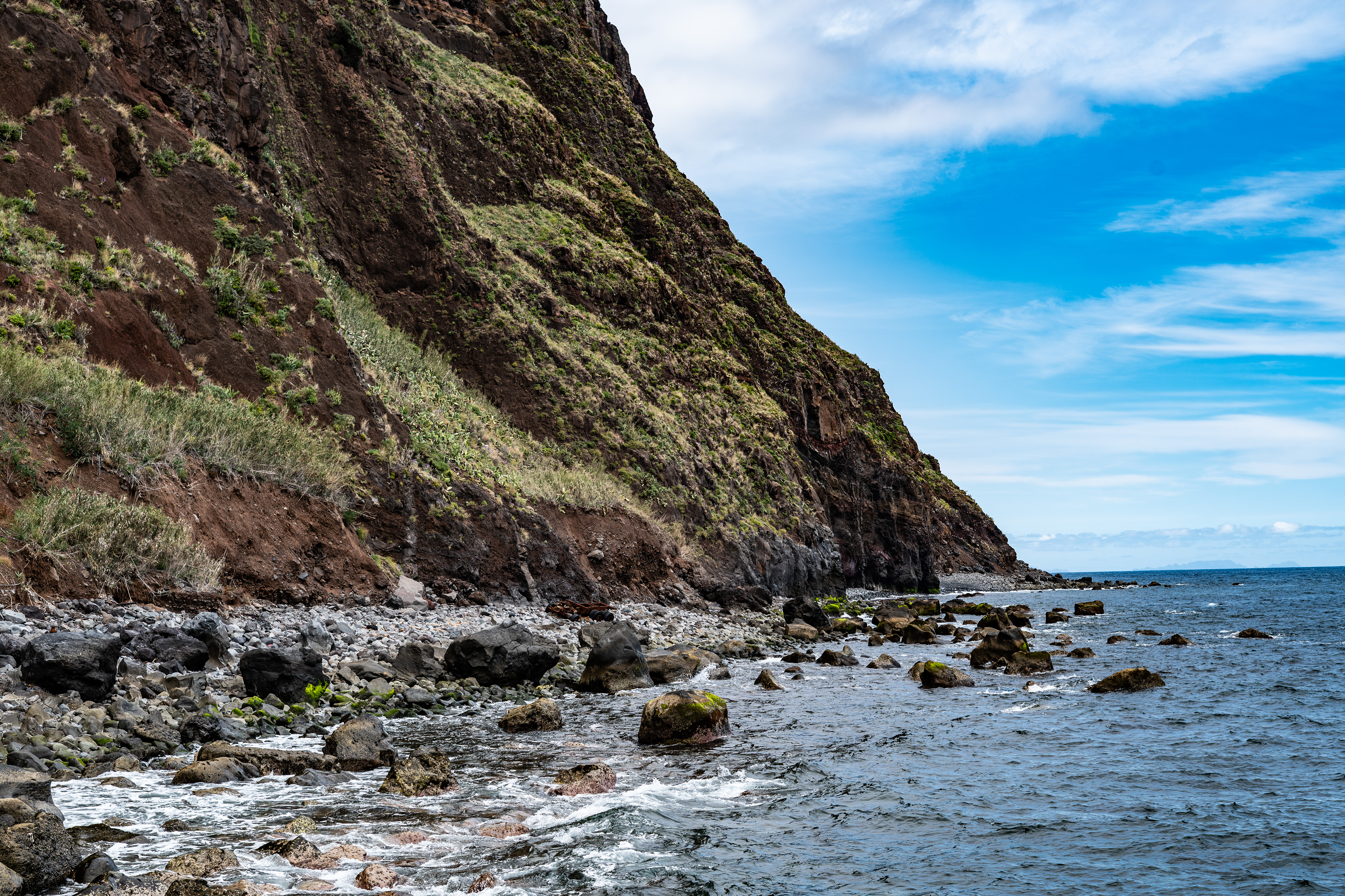 a rocky coastline with steep, rugged cliffs