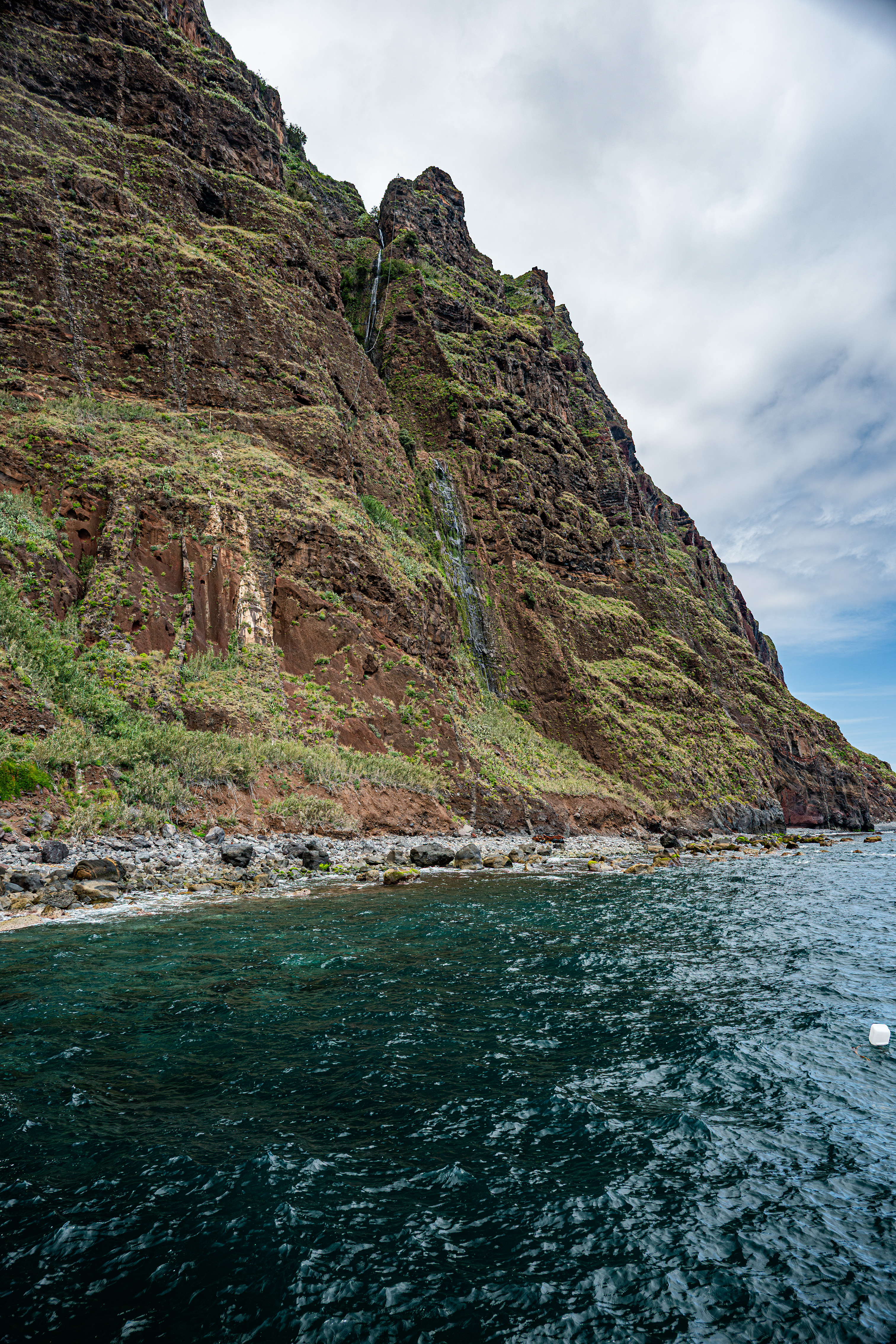 Waterfalls cascade down the cliffs