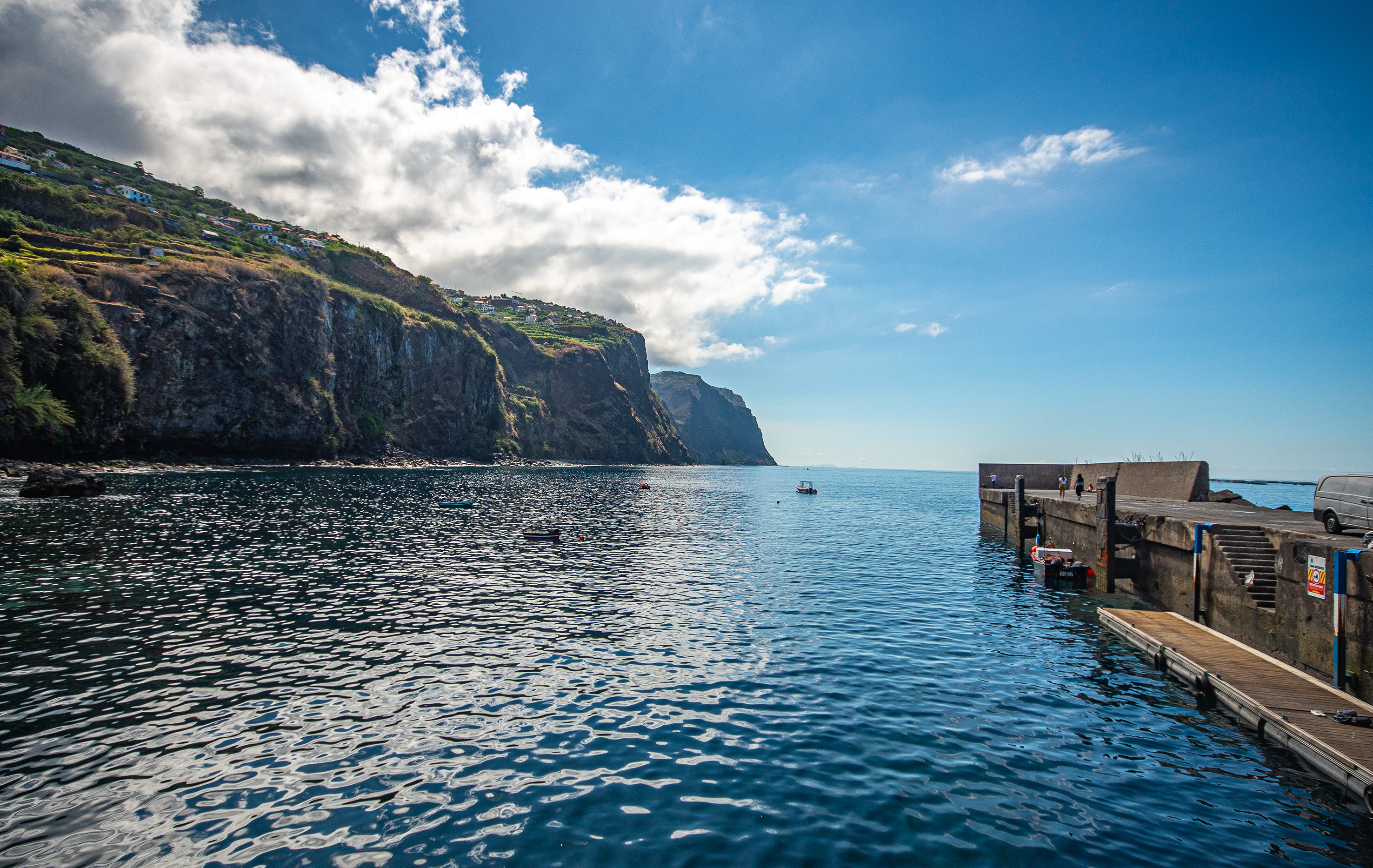coastal scene with a clear blue sky and scattered clouds