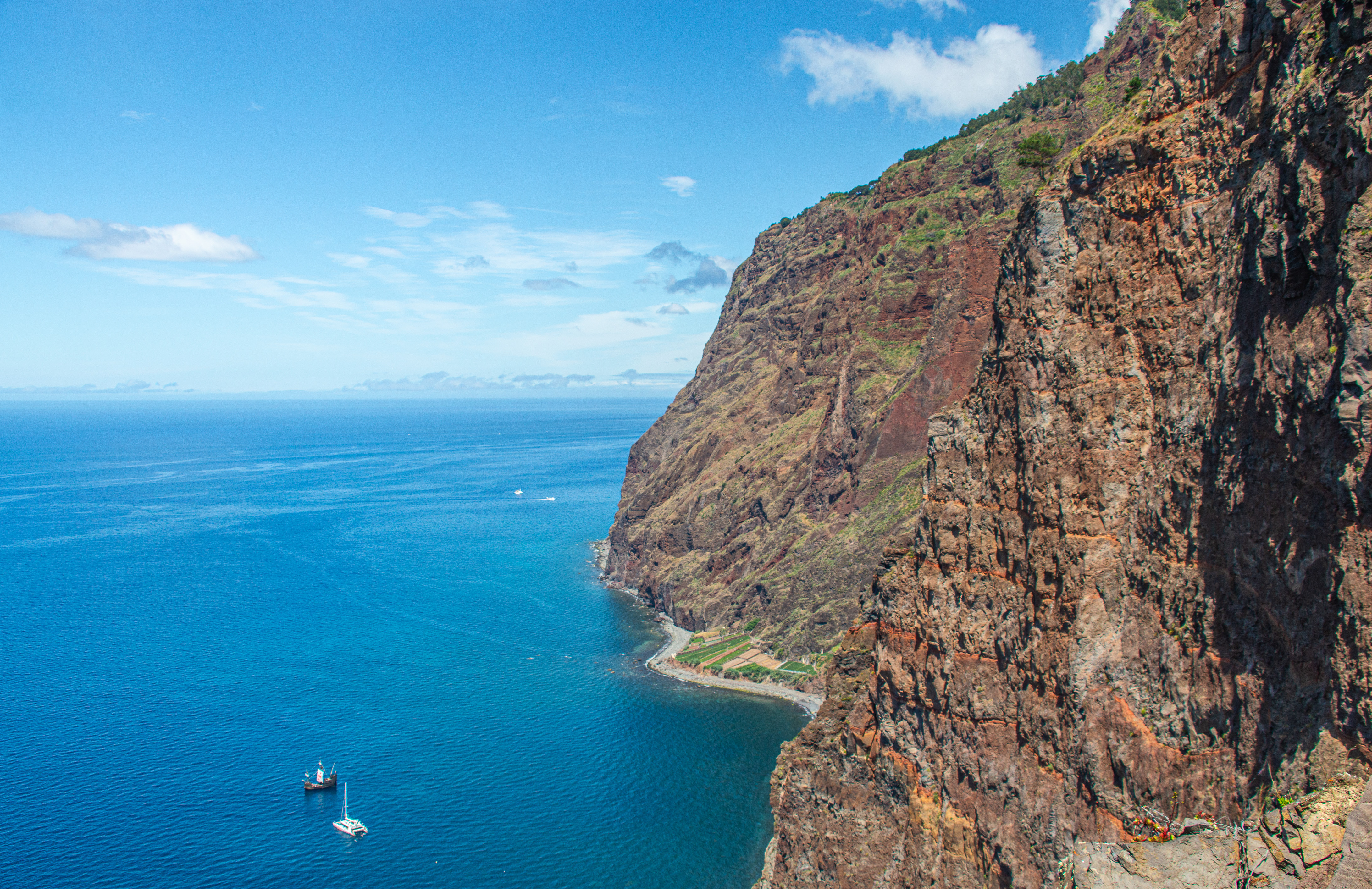 a stunning coastal landscape with steep, rugged cliffs
