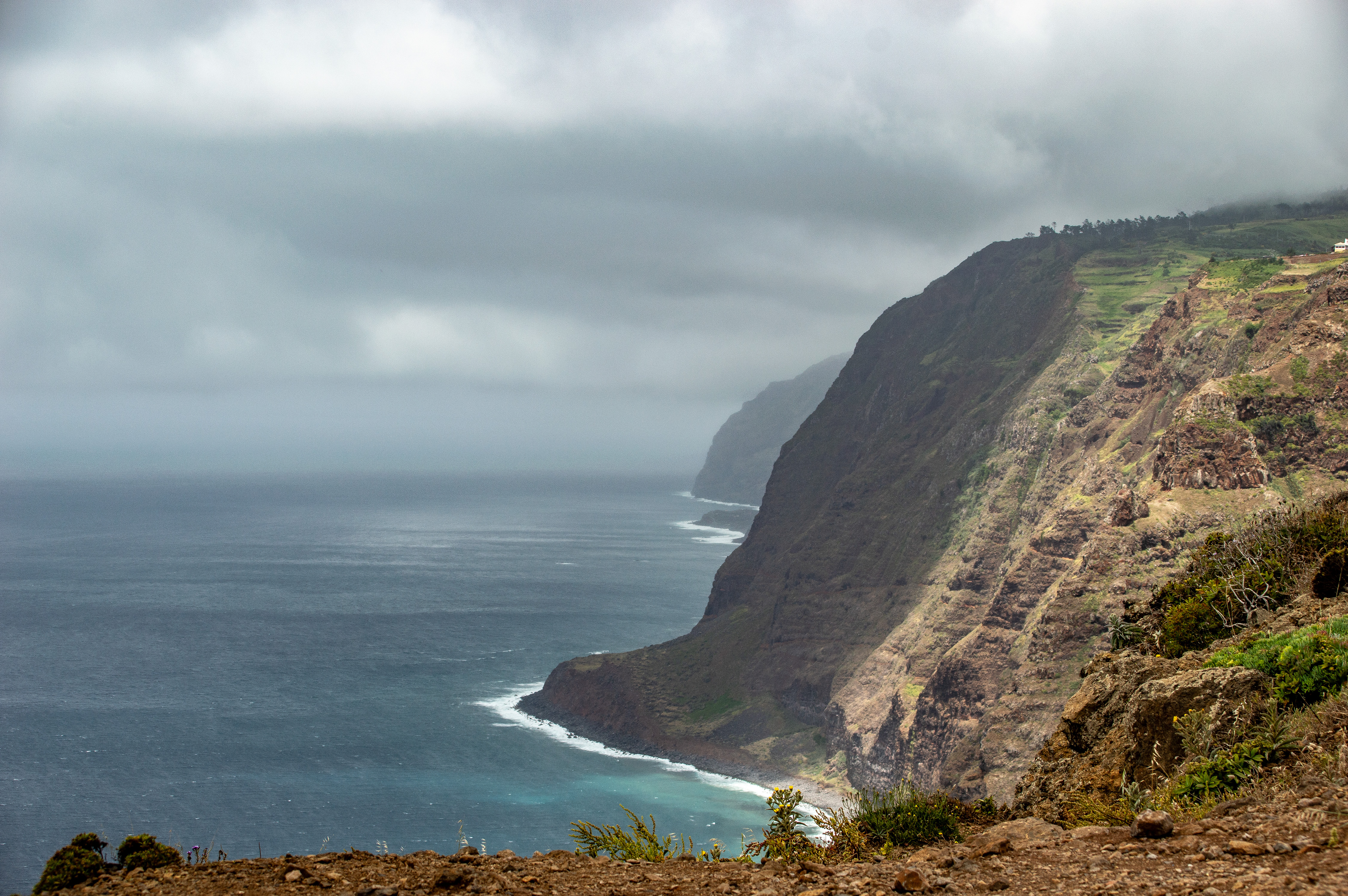 steep cliffs and a cloudy sky overhead