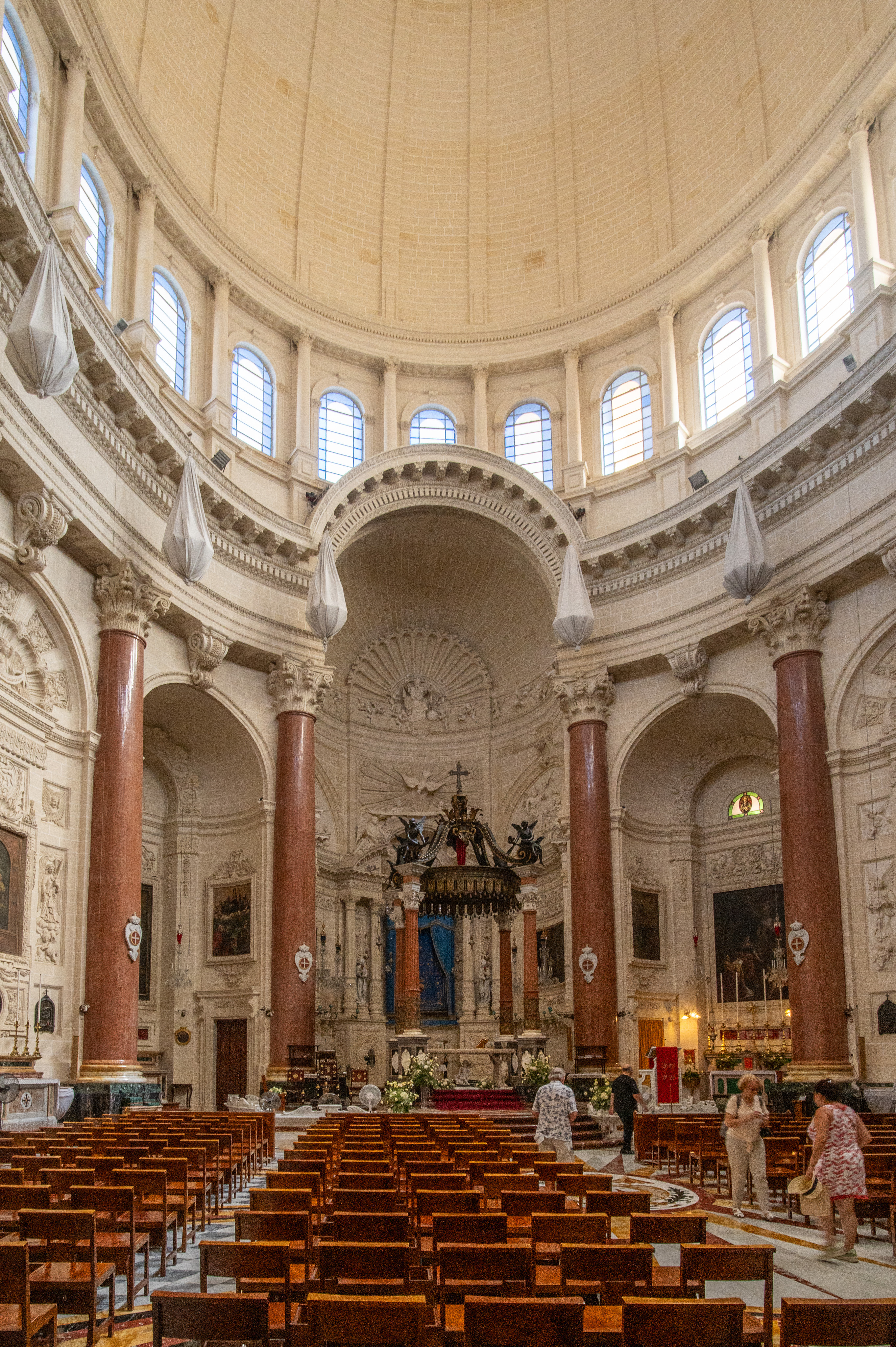 ornate church with a high, domed ceiling and large arched windows.