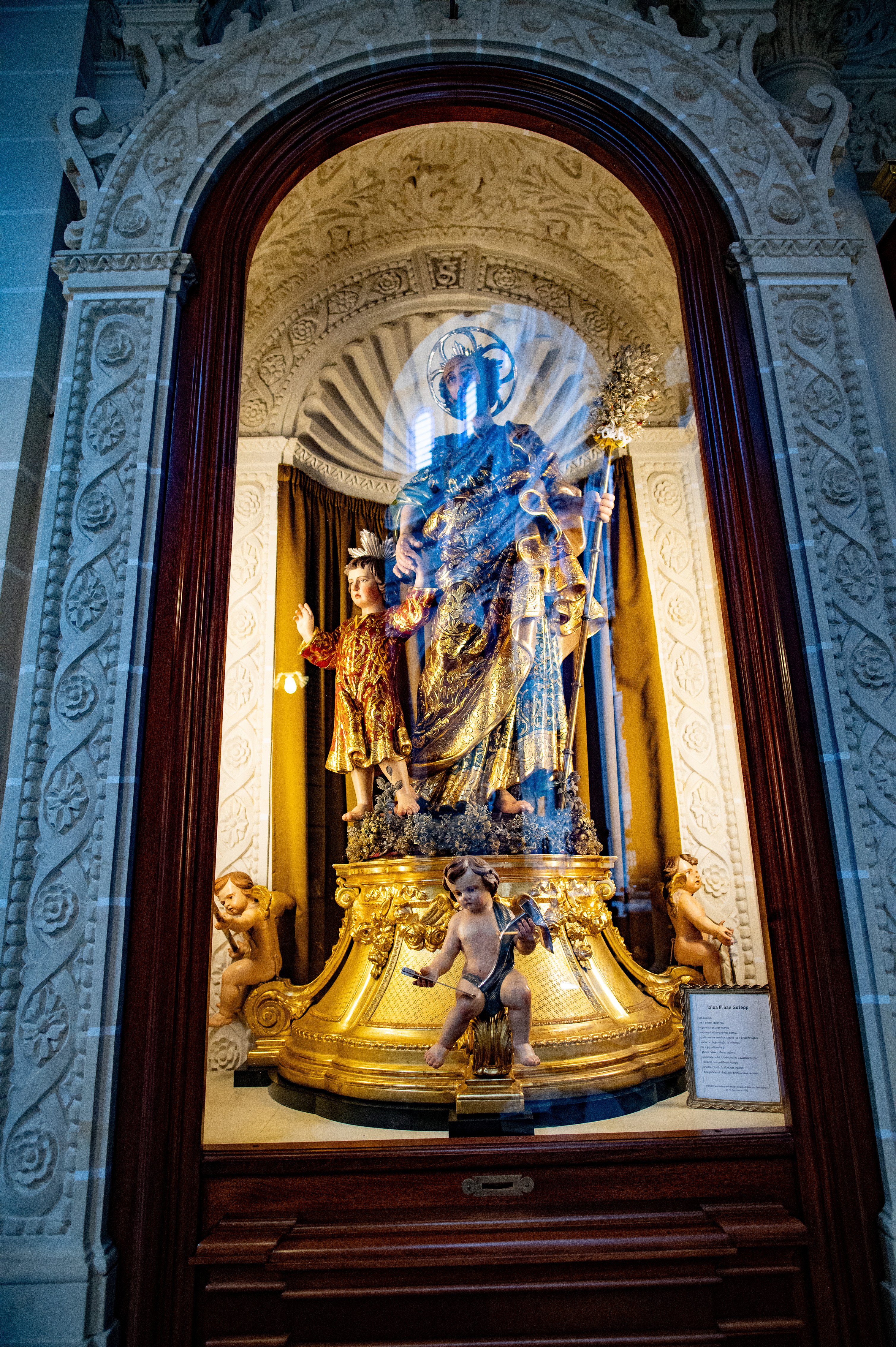 a central figure adorned in blue and gold robes